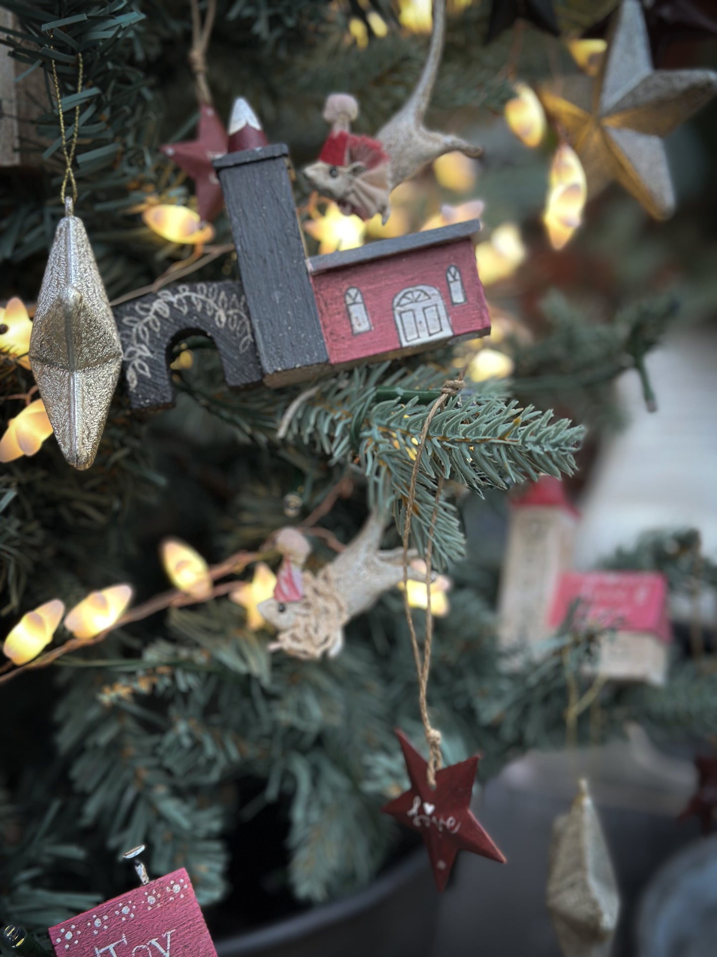 A pretty vintage German Erzgebirge Putz wooden village house painted with a Christmas quote