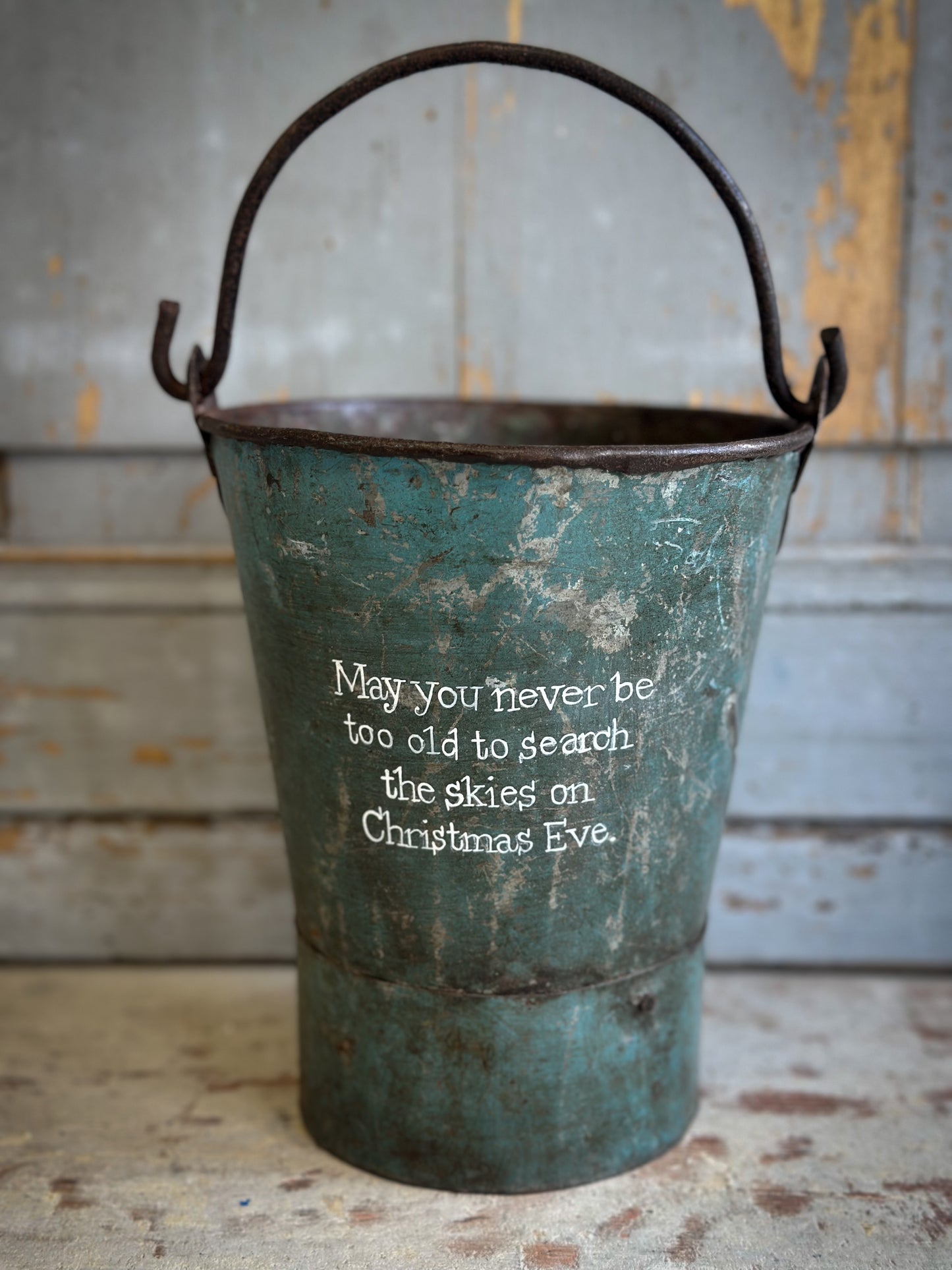 A Recycled Metal Mini Christmas Tree Bucket With A Hand Painted Quote