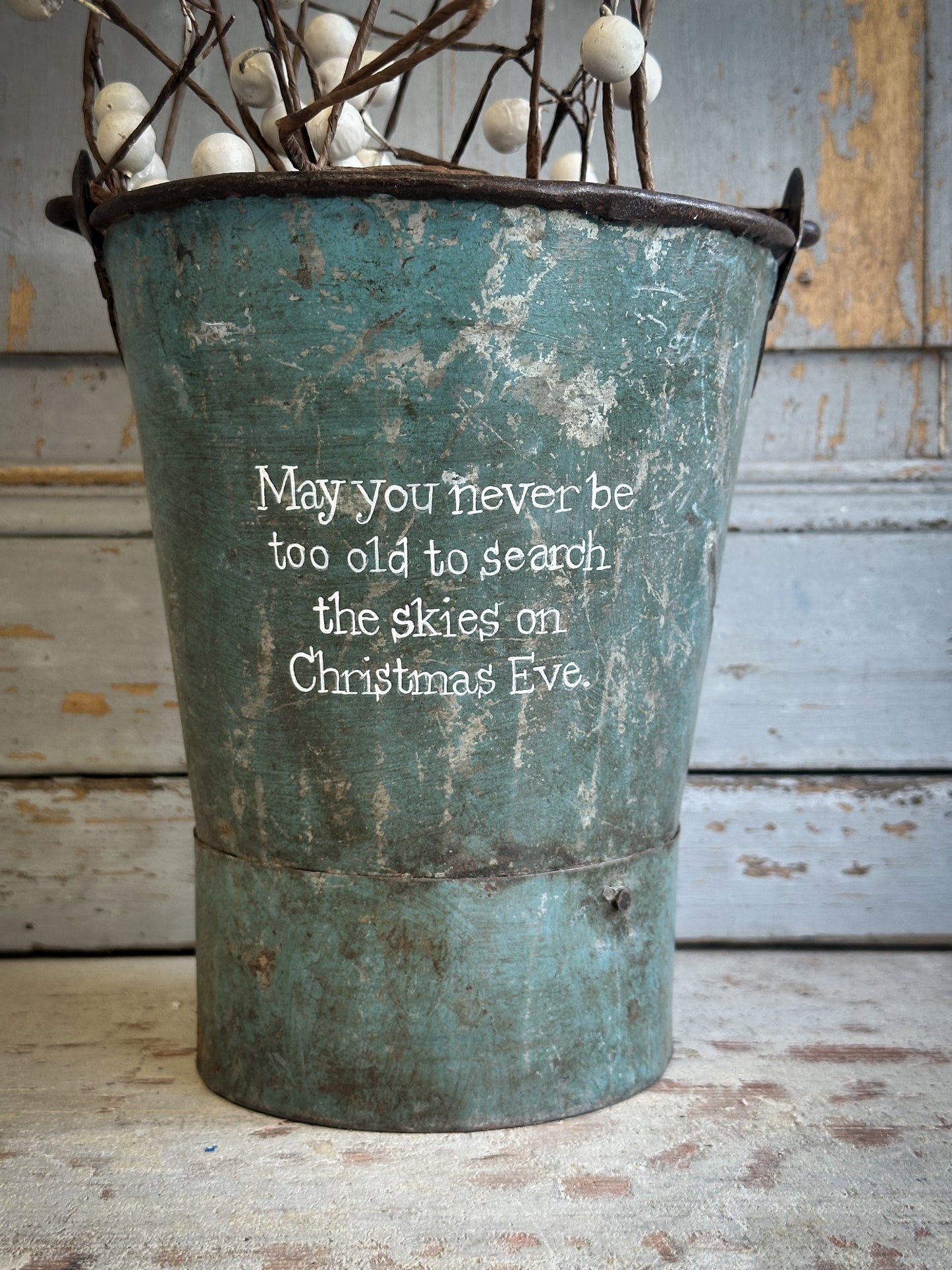 A Recycled Metal Mini Christmas Tree Bucket With A Hand Painted Quote
