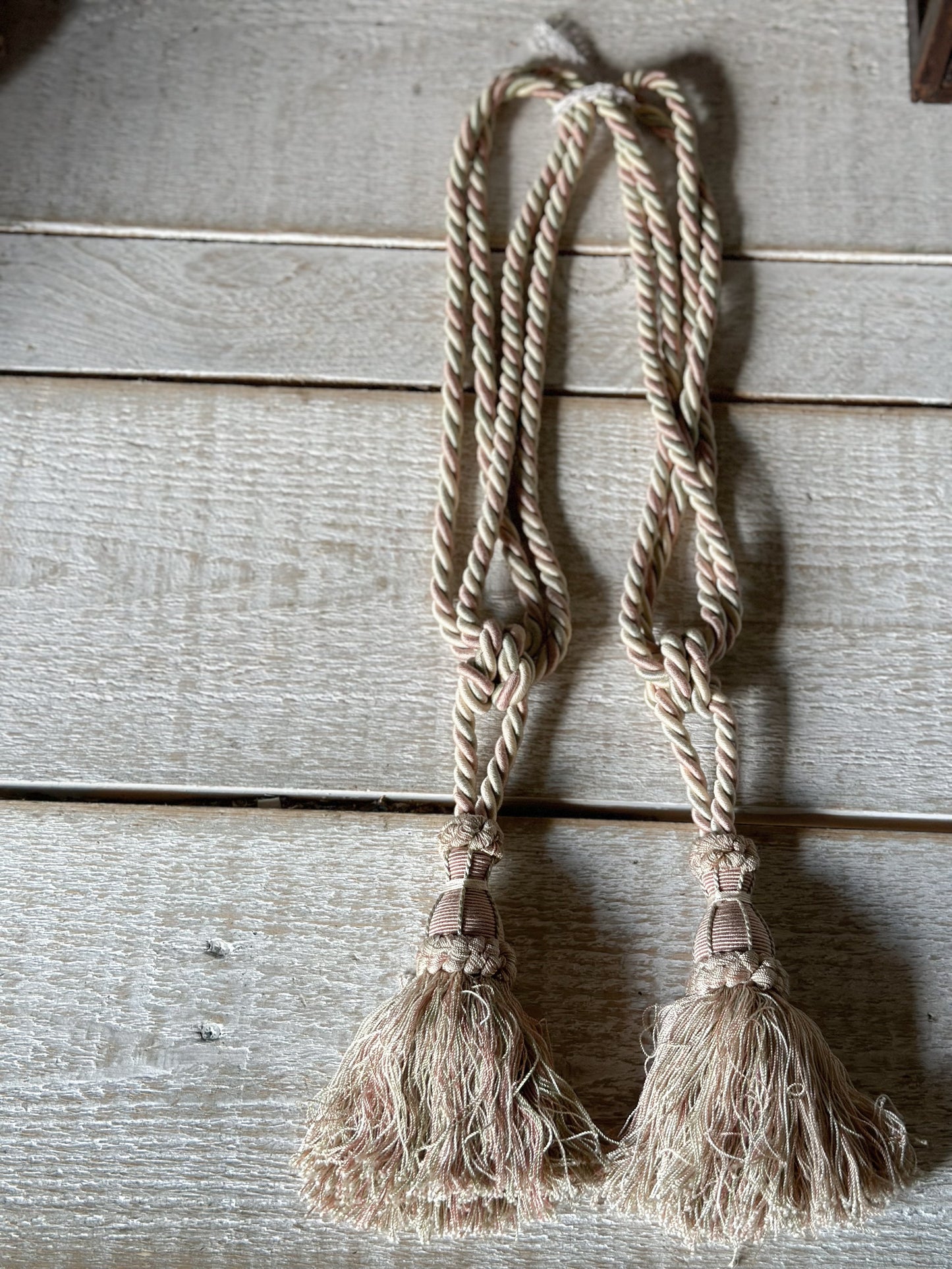 A pair of pretty vintage pastel pink, sage green and ivory curtain tie backs