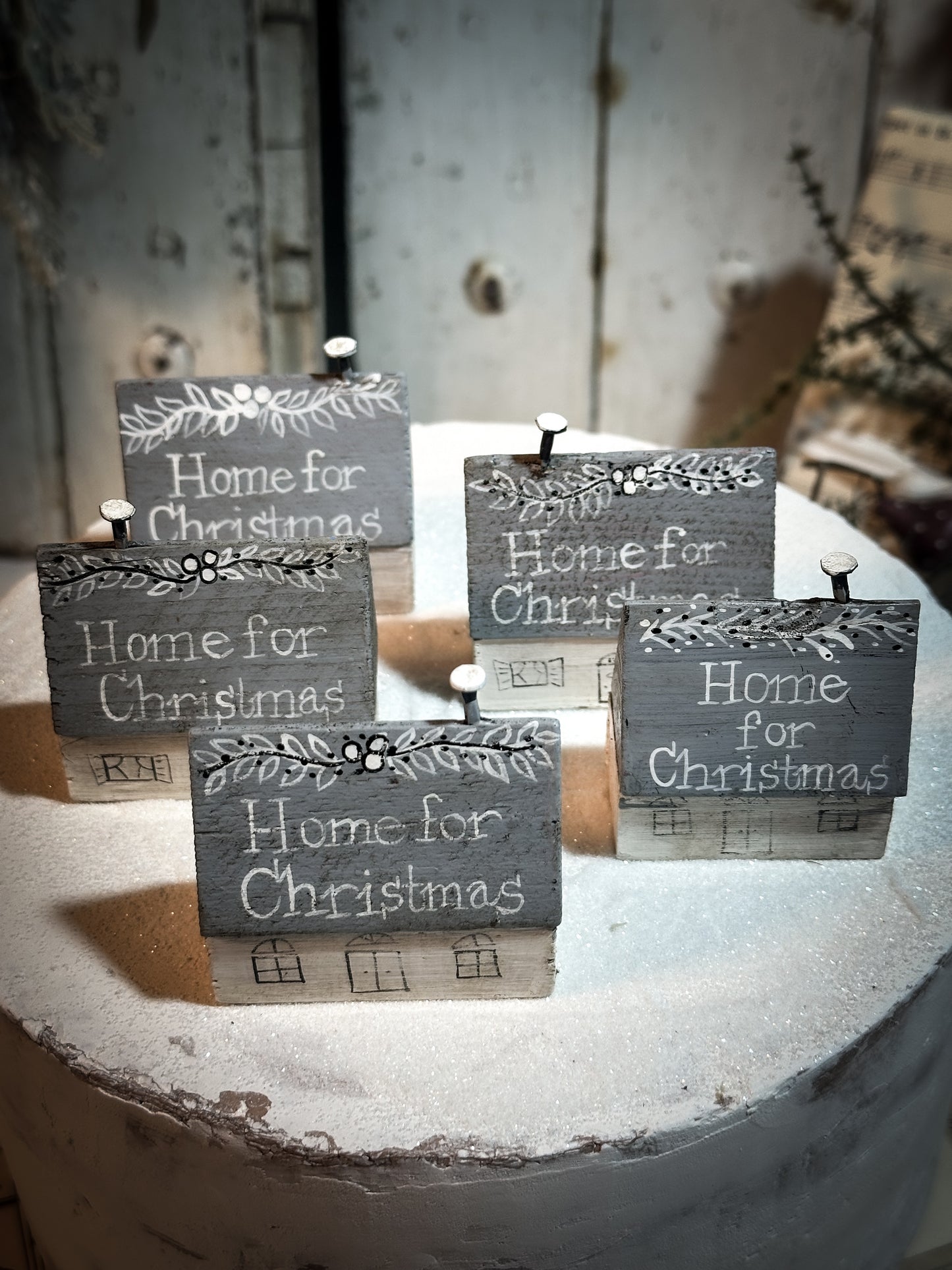 A pretty vintage German Erzgebirge Putz wooden village house painted with a Christmas quote