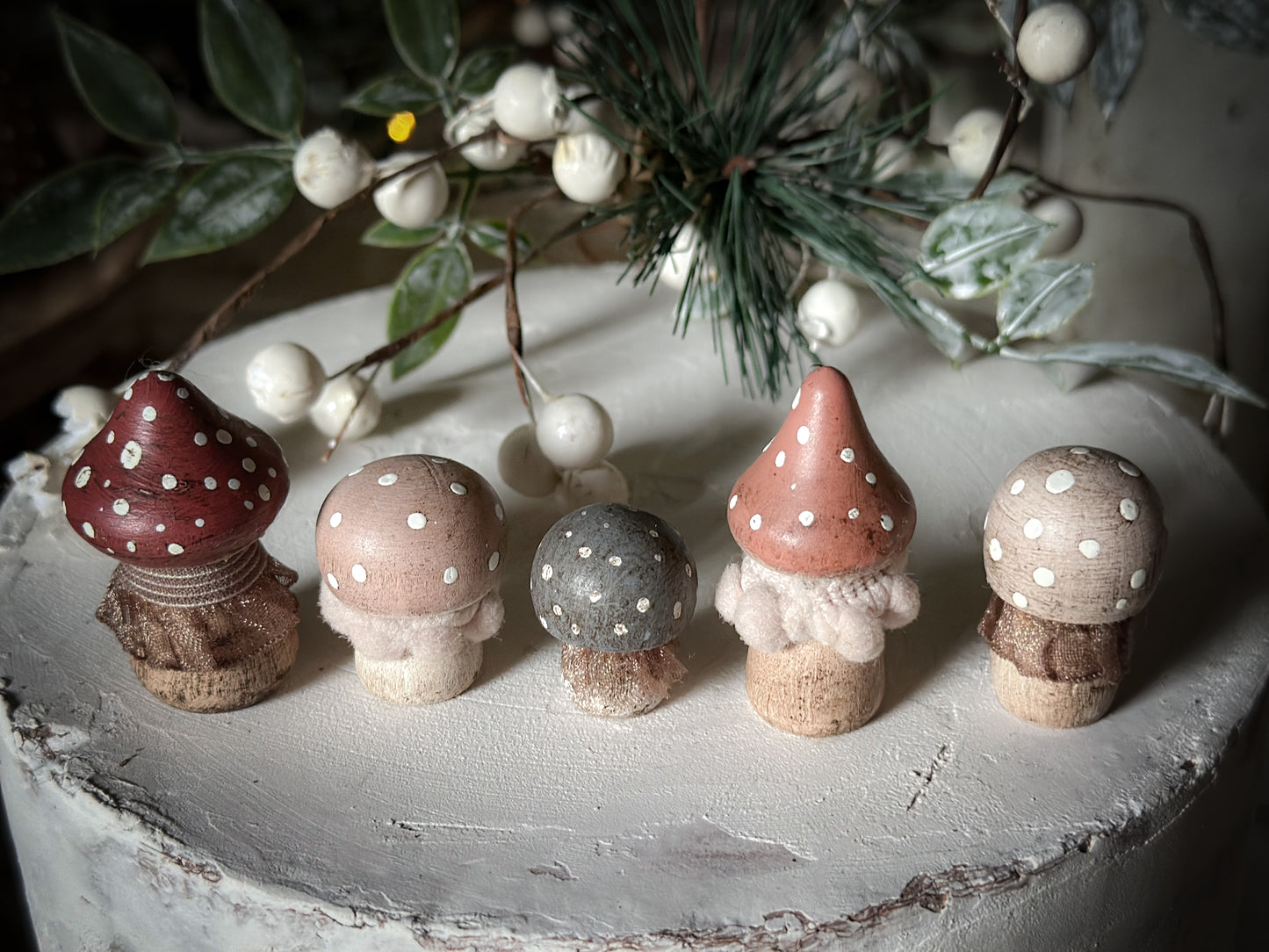 A set of five wooden hand painted and trimmed Christmas village toadstools