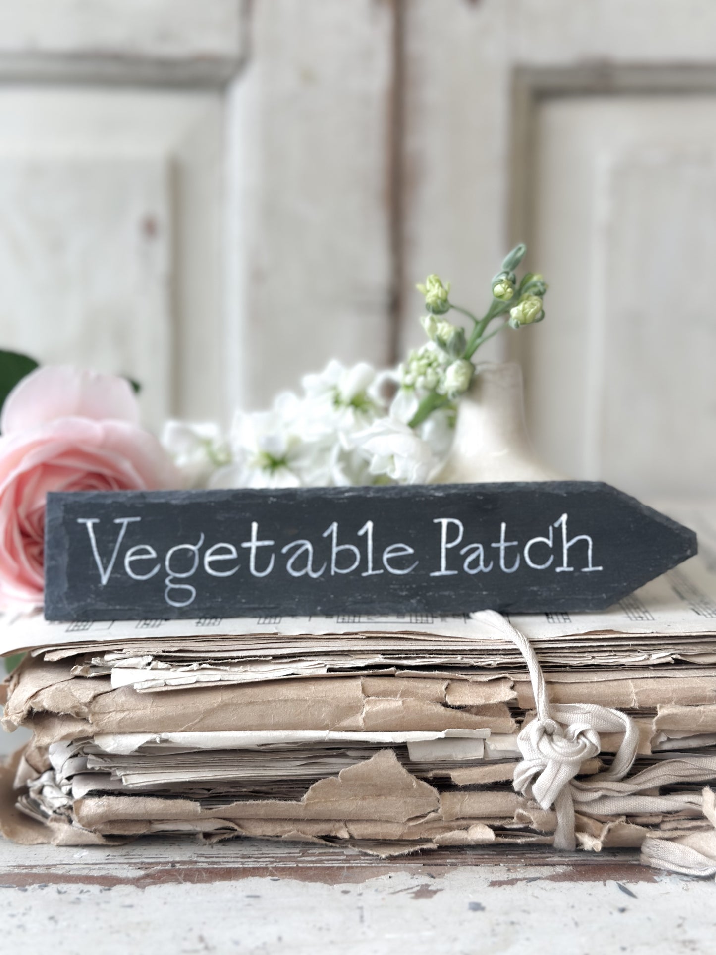 A small hand painted Victorian Welsh slate sign in lower case “Vegetable Patch”