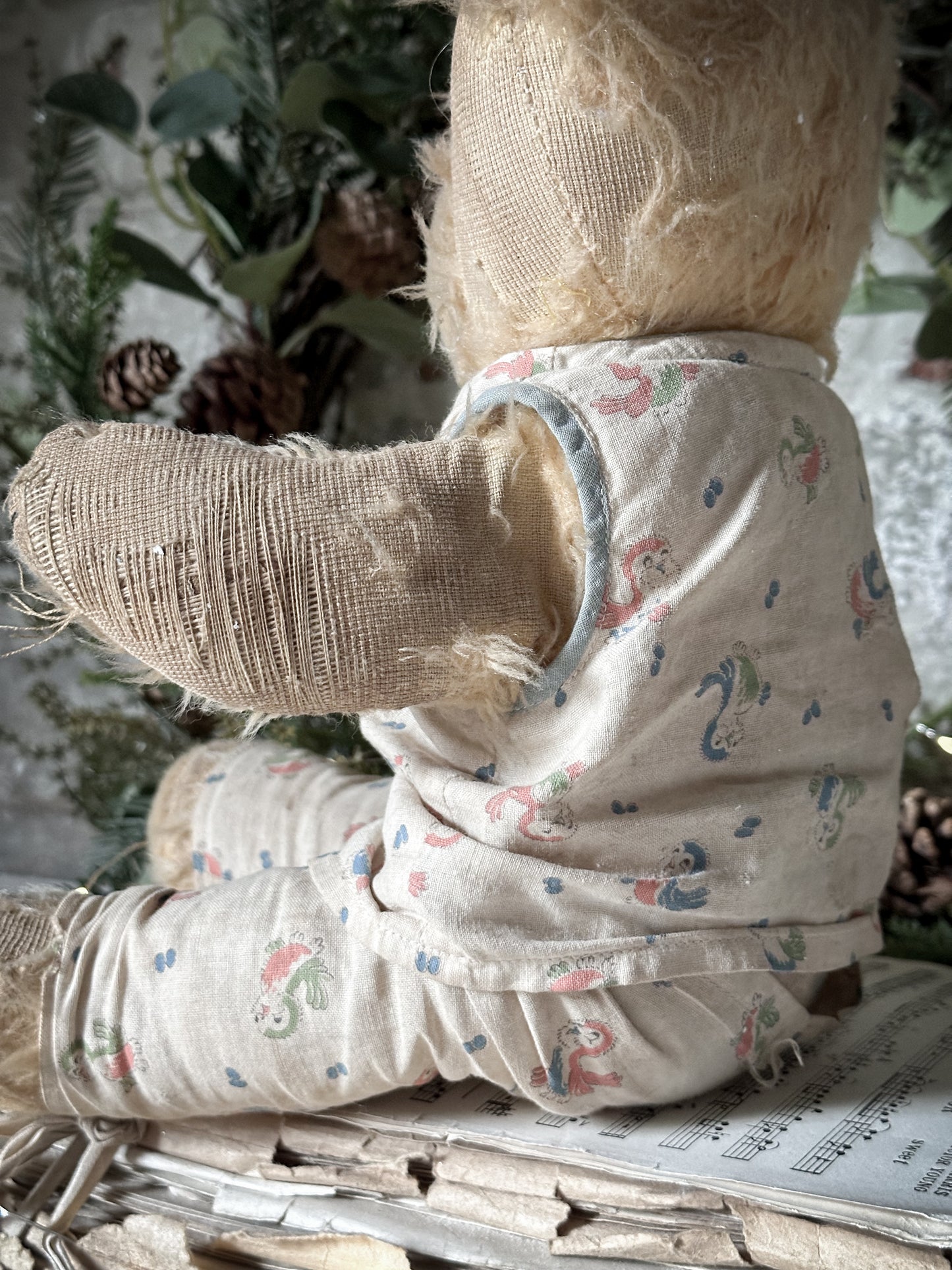 A lovely antique teddy made in original cotton pyjamas