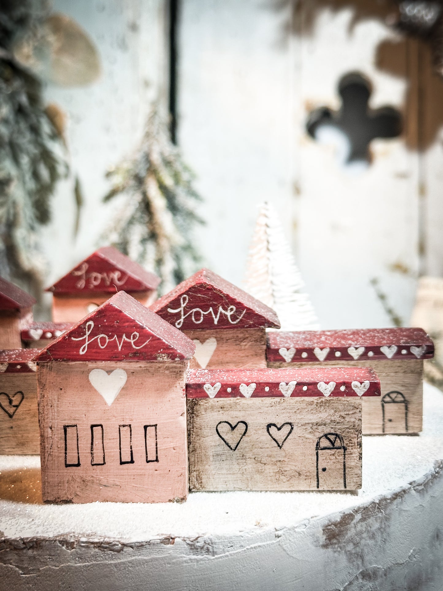 A pretty vintage German Erzgebirge Putz wooden village house painted with a Christmas quote