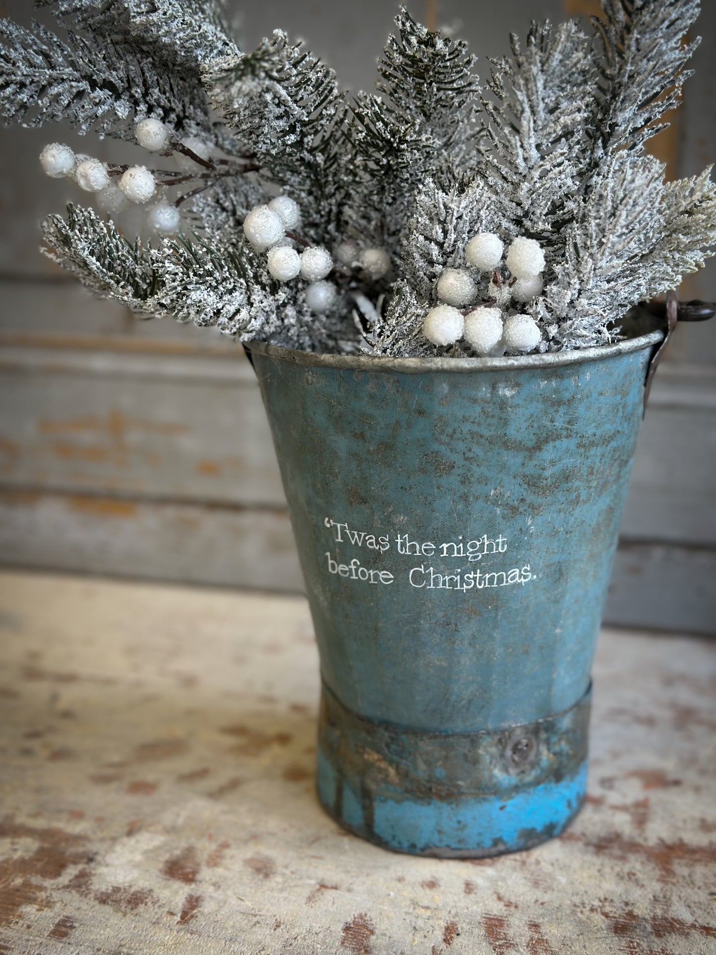 A Recycled Metal Mini Christmas Tree Bucket With A Hand Painted Quote