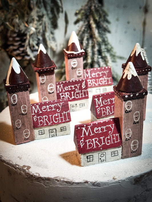 A pretty vintage German Erzgebirge Putz wooden village house painted with a Christmas quote