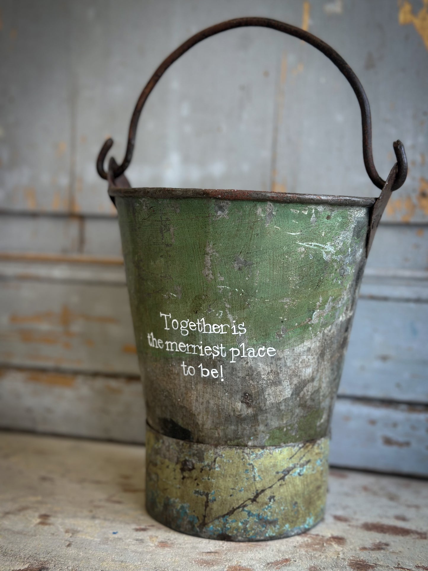 A Recycled Metal Mini Christmas Tree Bucket With A Hand Painted Quote