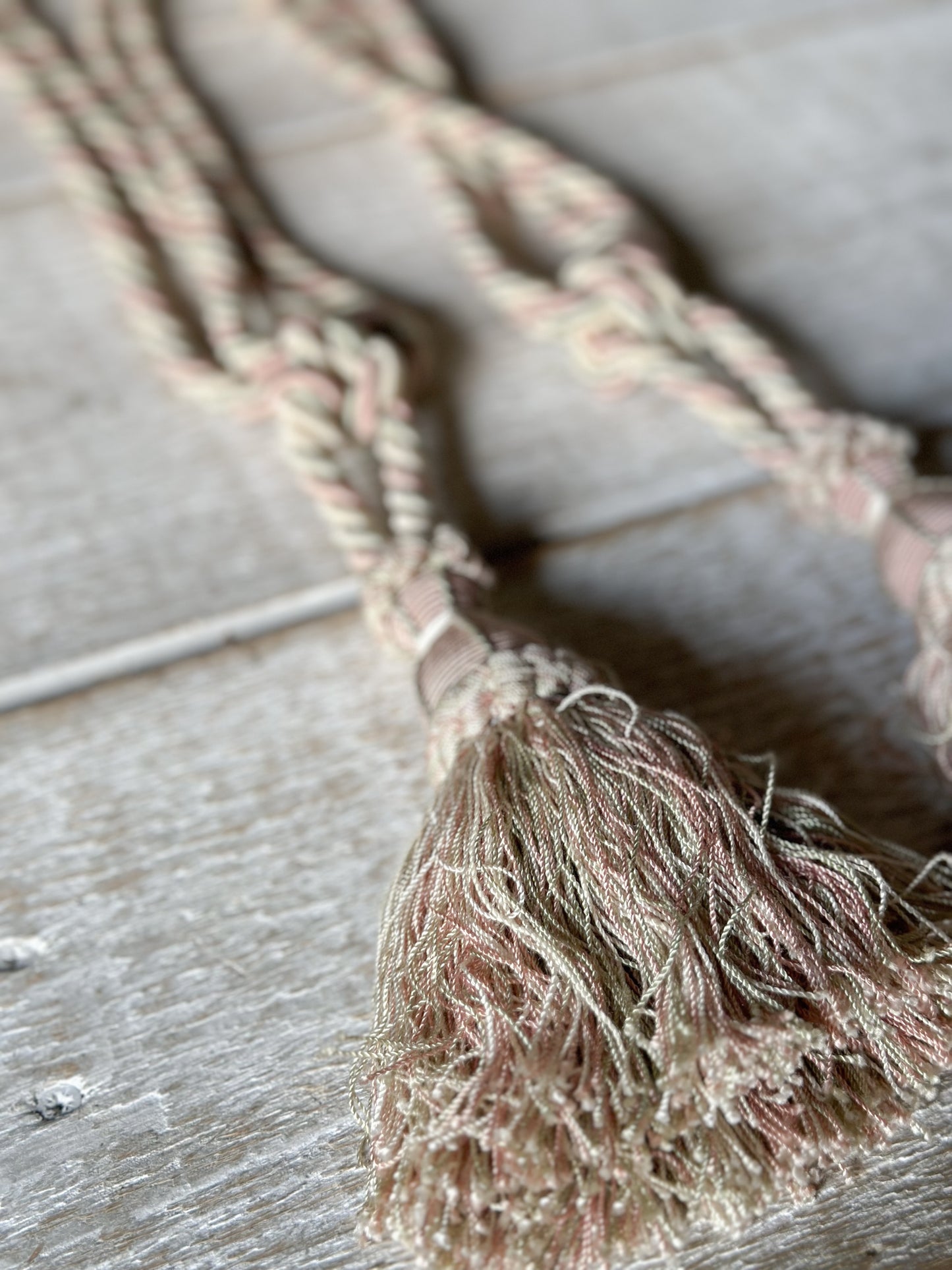 A pair of pretty vintage pastel pink, sage green and ivory curtain tie backs