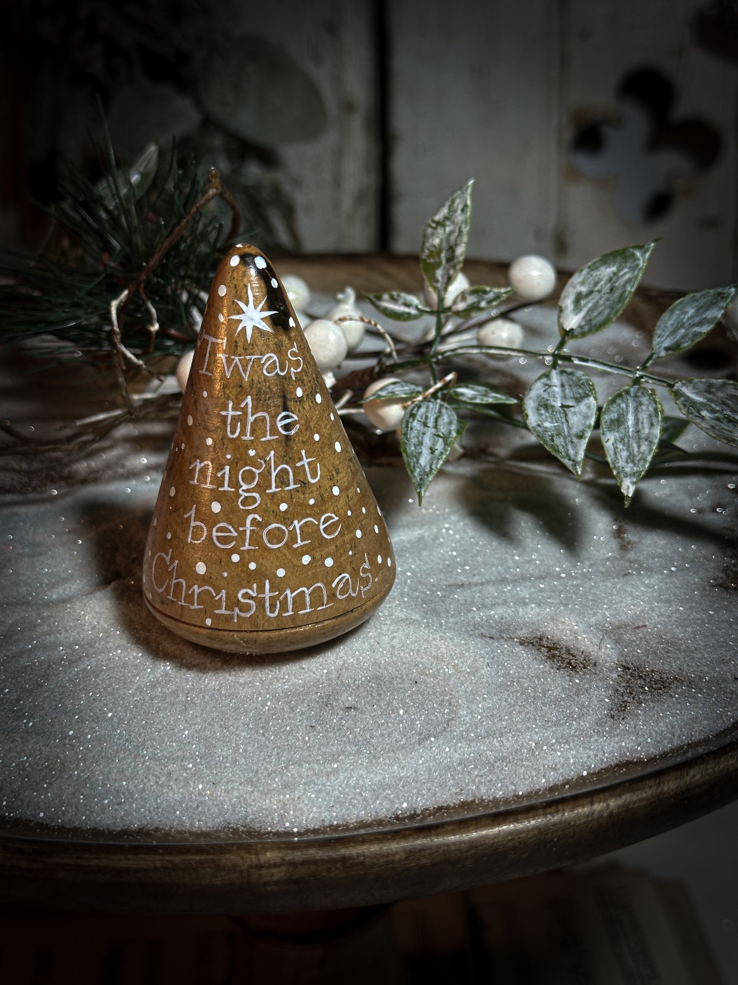 A hand painted quote on a lignum vitae wood plumber’s turnpin with a Christmas quote