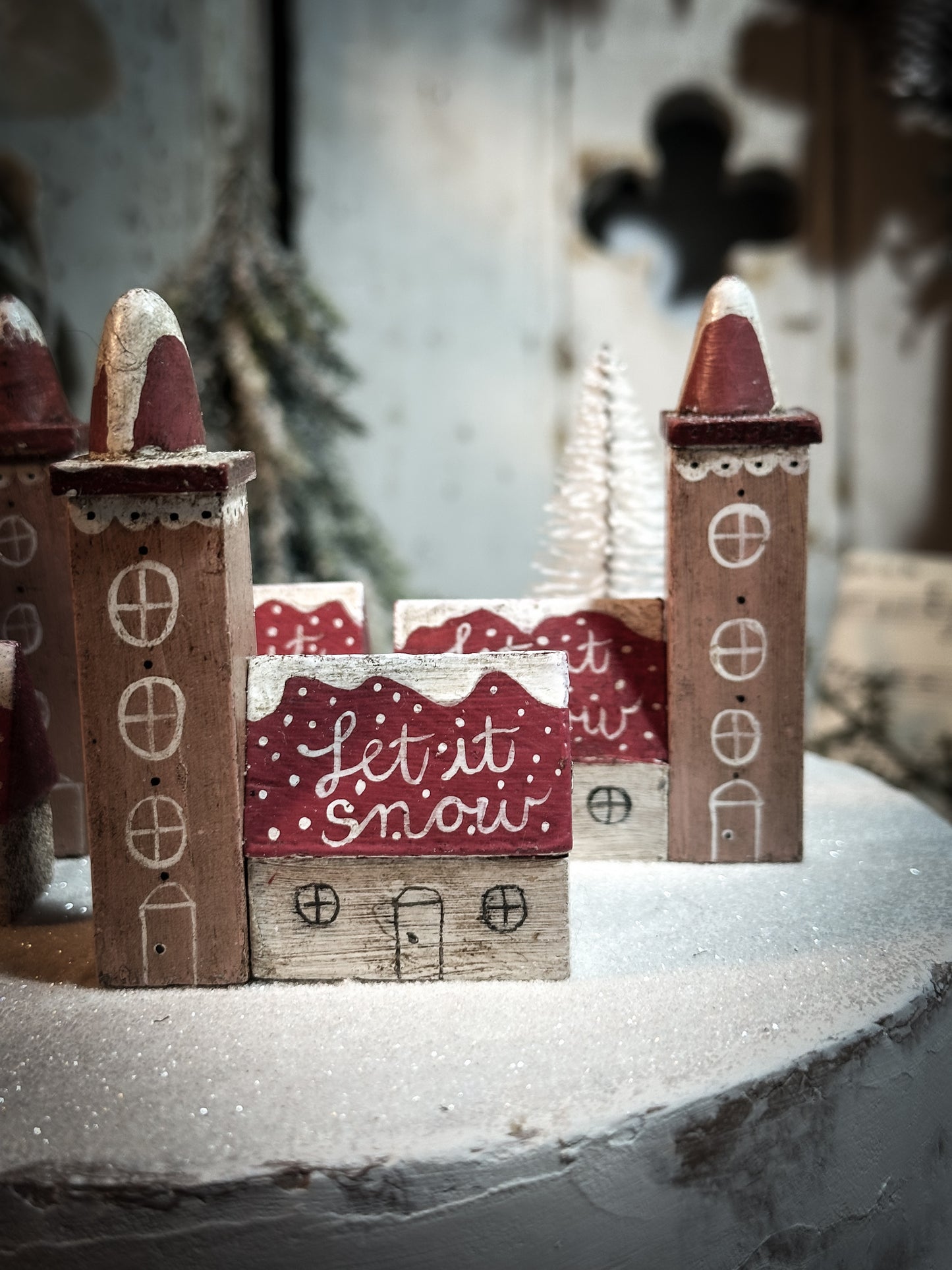 A pretty vintage German Erzgebirge Putz wooden village house painted with a Christmas quote