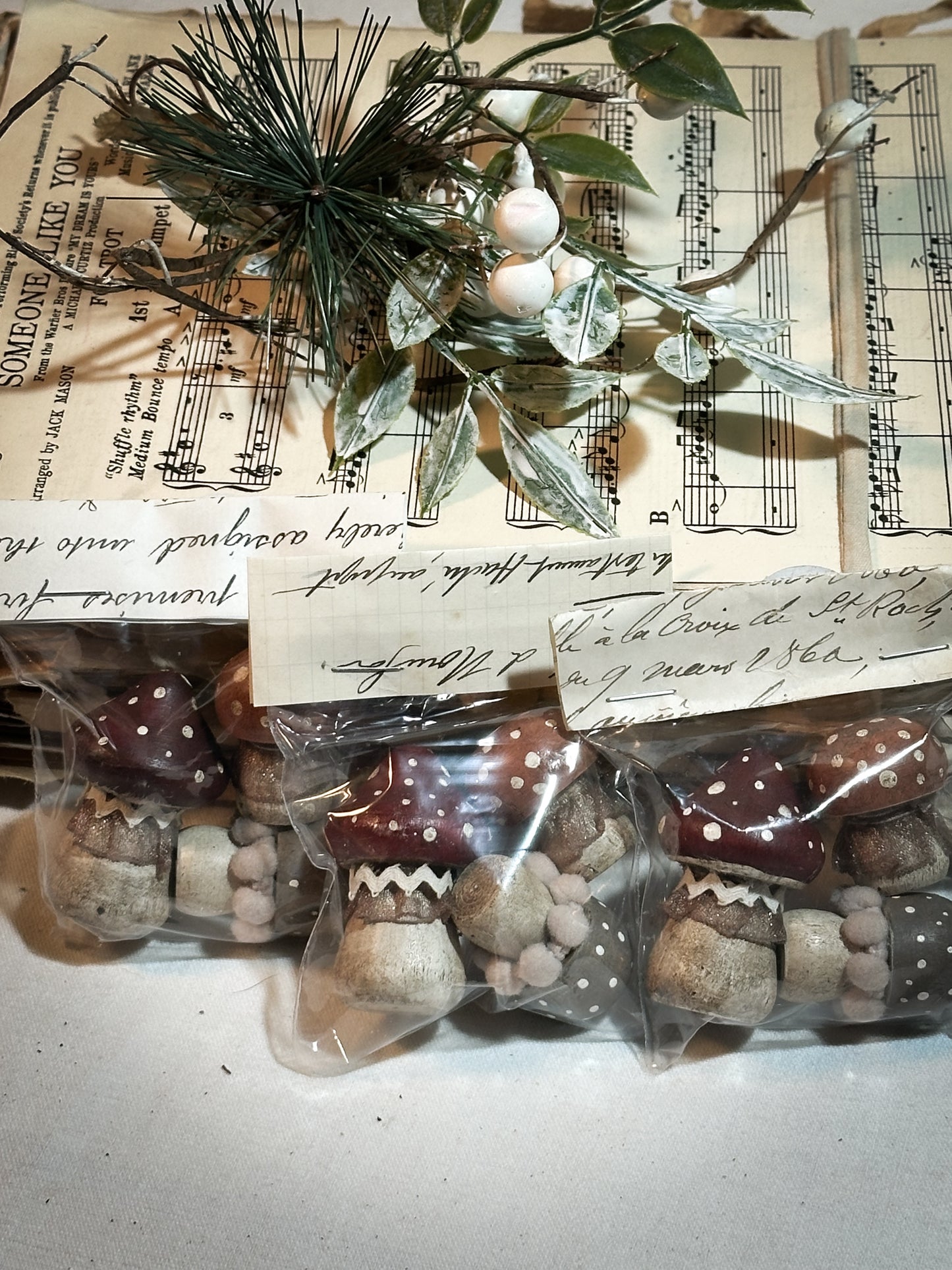 A set of three wooden hand painted and trimmed Christmas village toadstools