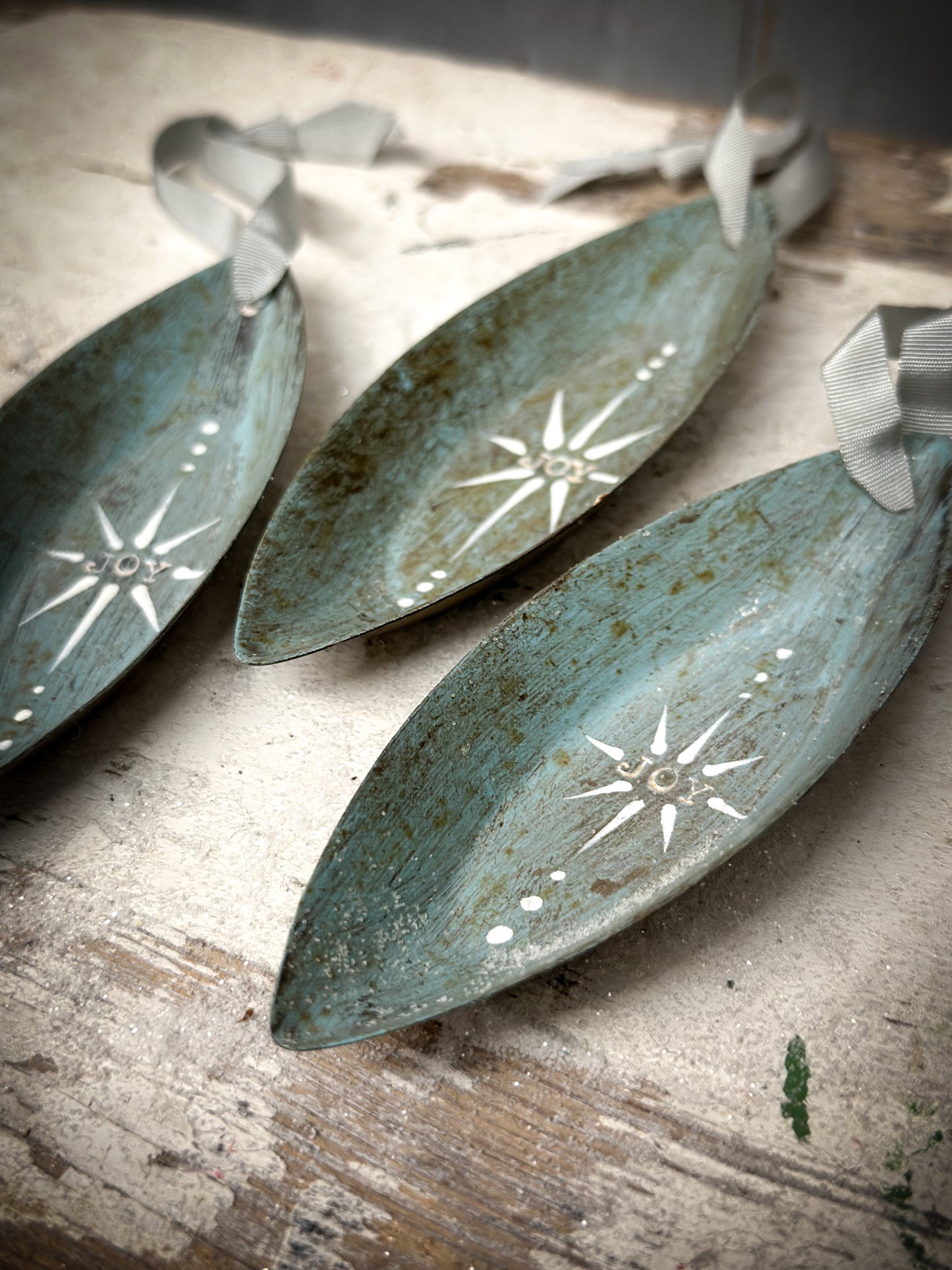 A Reworked French Patisserie Tin Christmas Decoration Stamped and Painted “Joy”