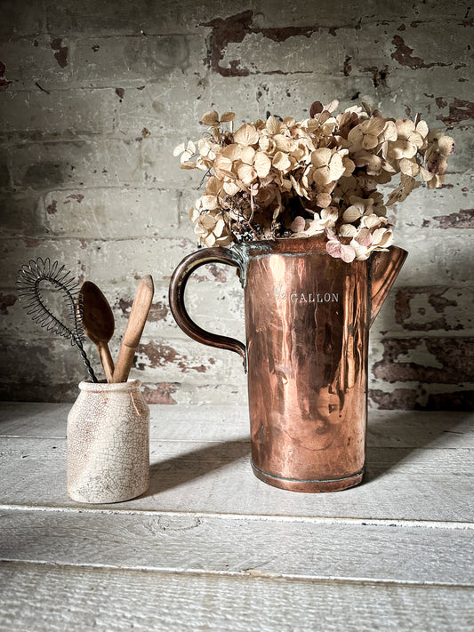 A fabulous antique 1/2 gallon copper measuring jug