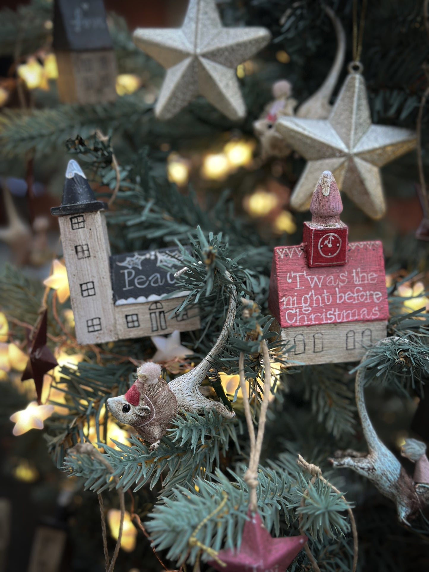 A pretty vintage German Erzgebirge Putz wooden village house painted with a Christmas quote