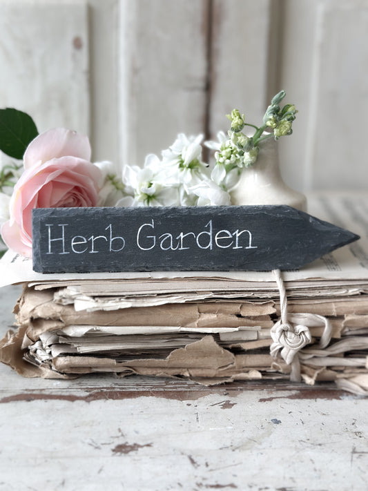 A small hand painted Victorian Welsh slate sign in lower case “ Herb Garden”