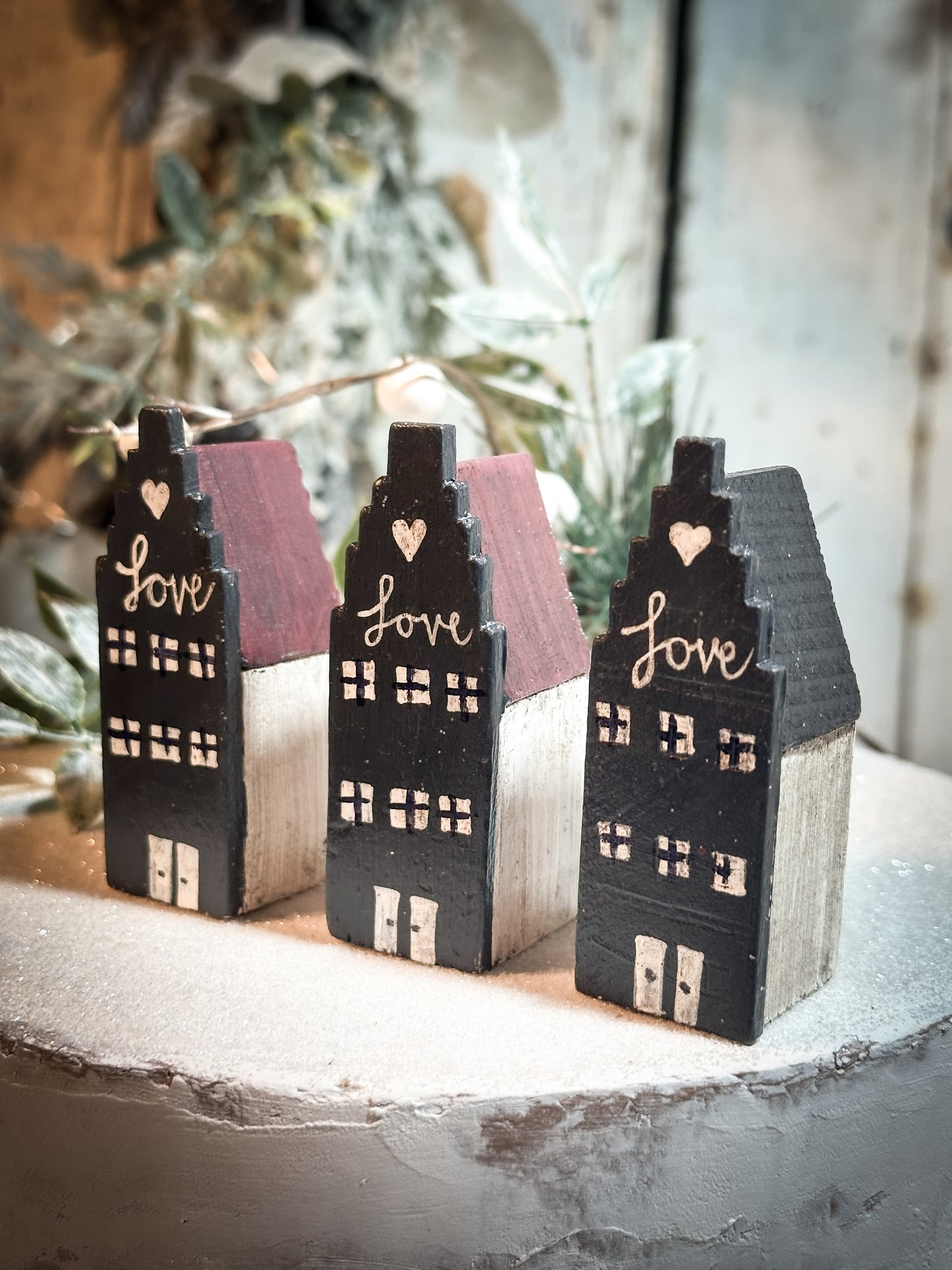 A pretty vintage German Erzgebirge Putz wooden village house painted with a Christmas quote