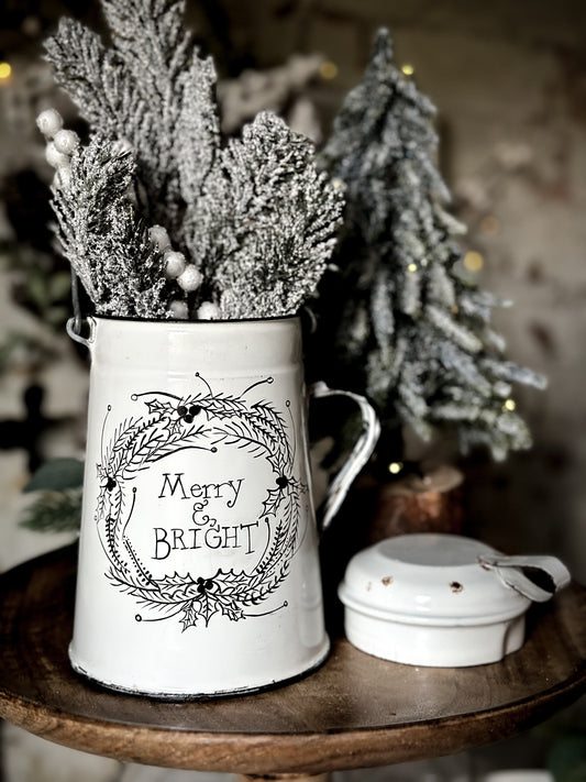 A white enamelware milk churn hand painted with a quote