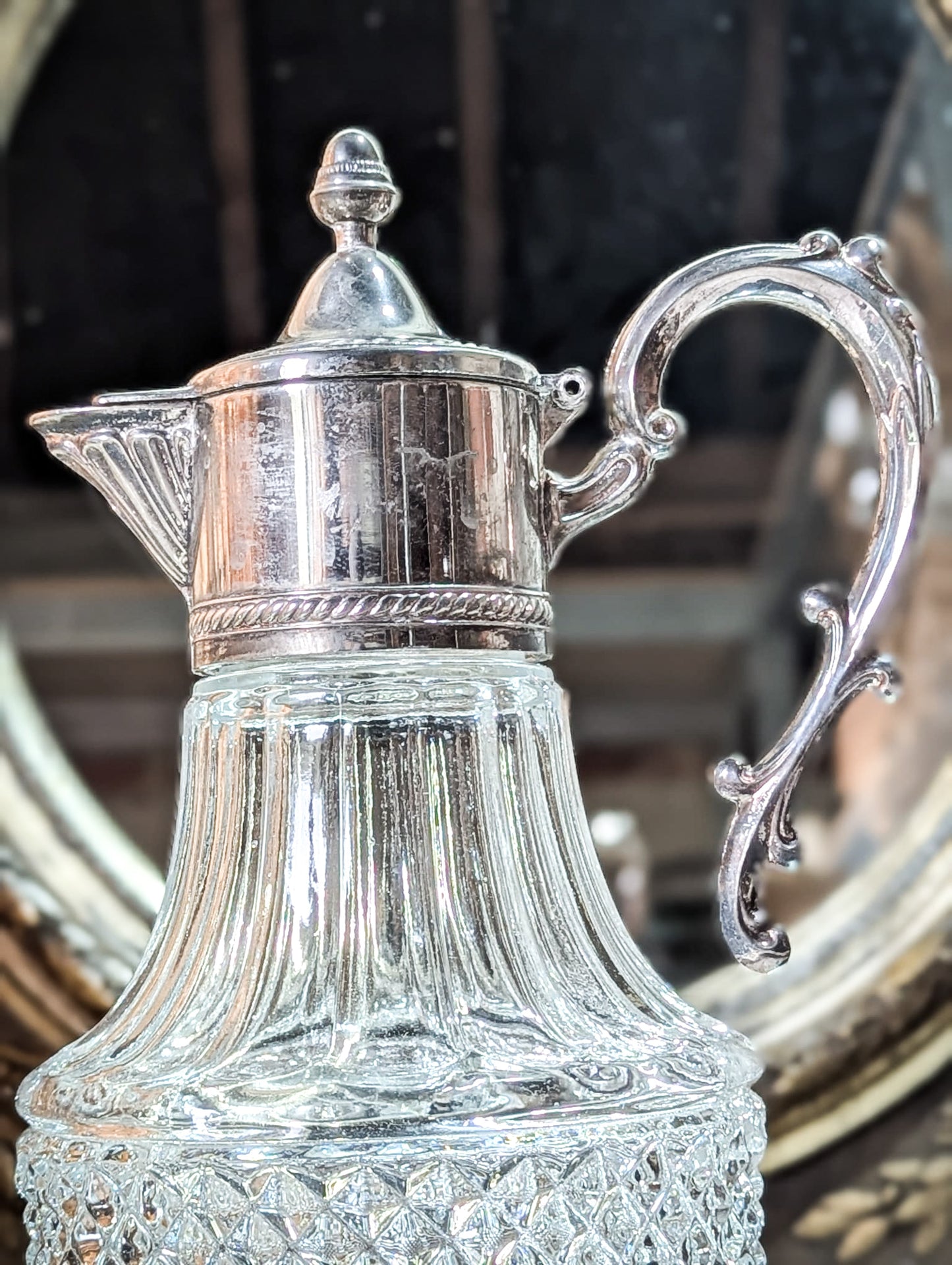 A vintage pressed glass silver plated wine jug