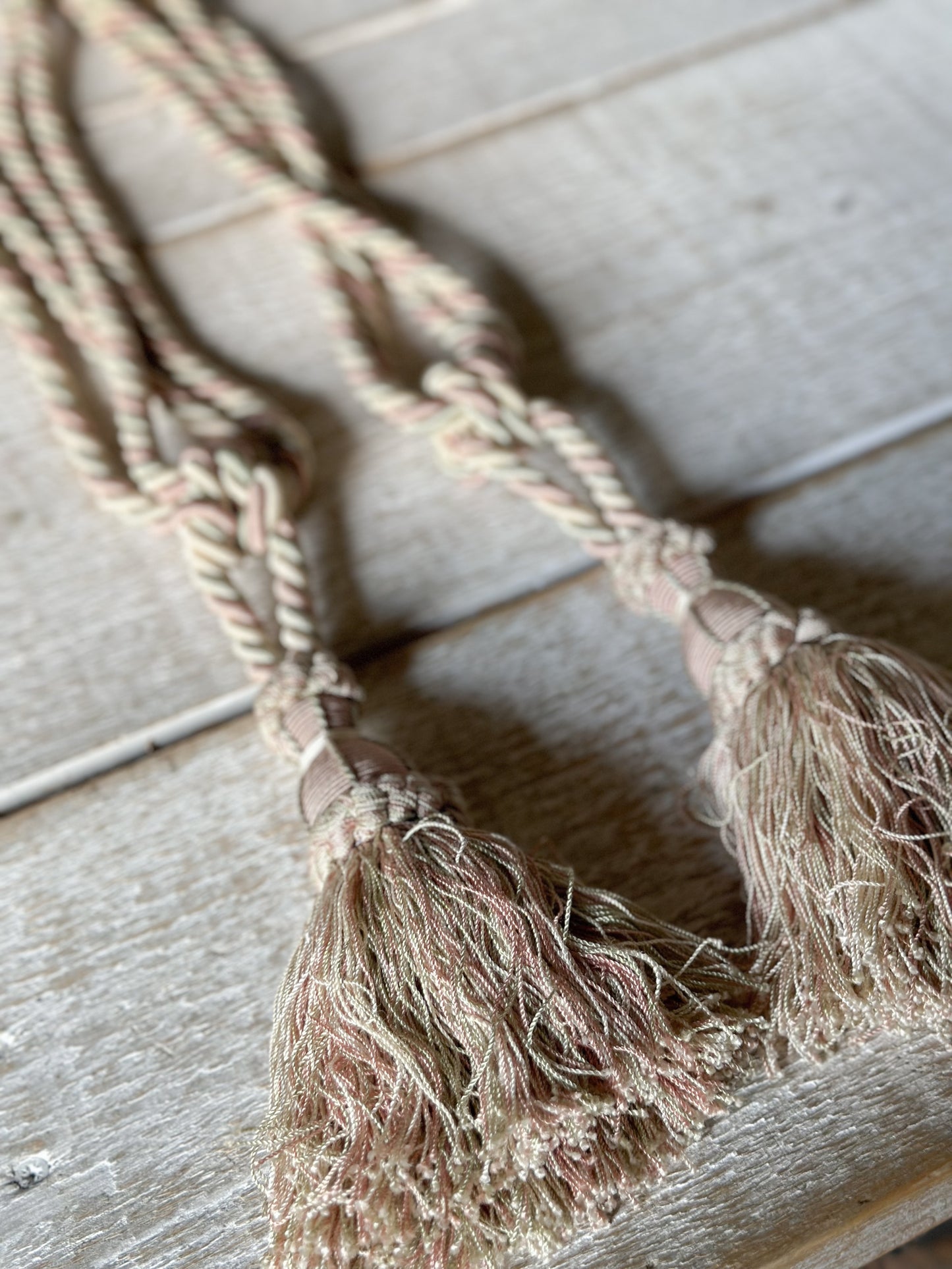 A pair of pretty vintage pastel pink, sage green and ivory curtain tie backs