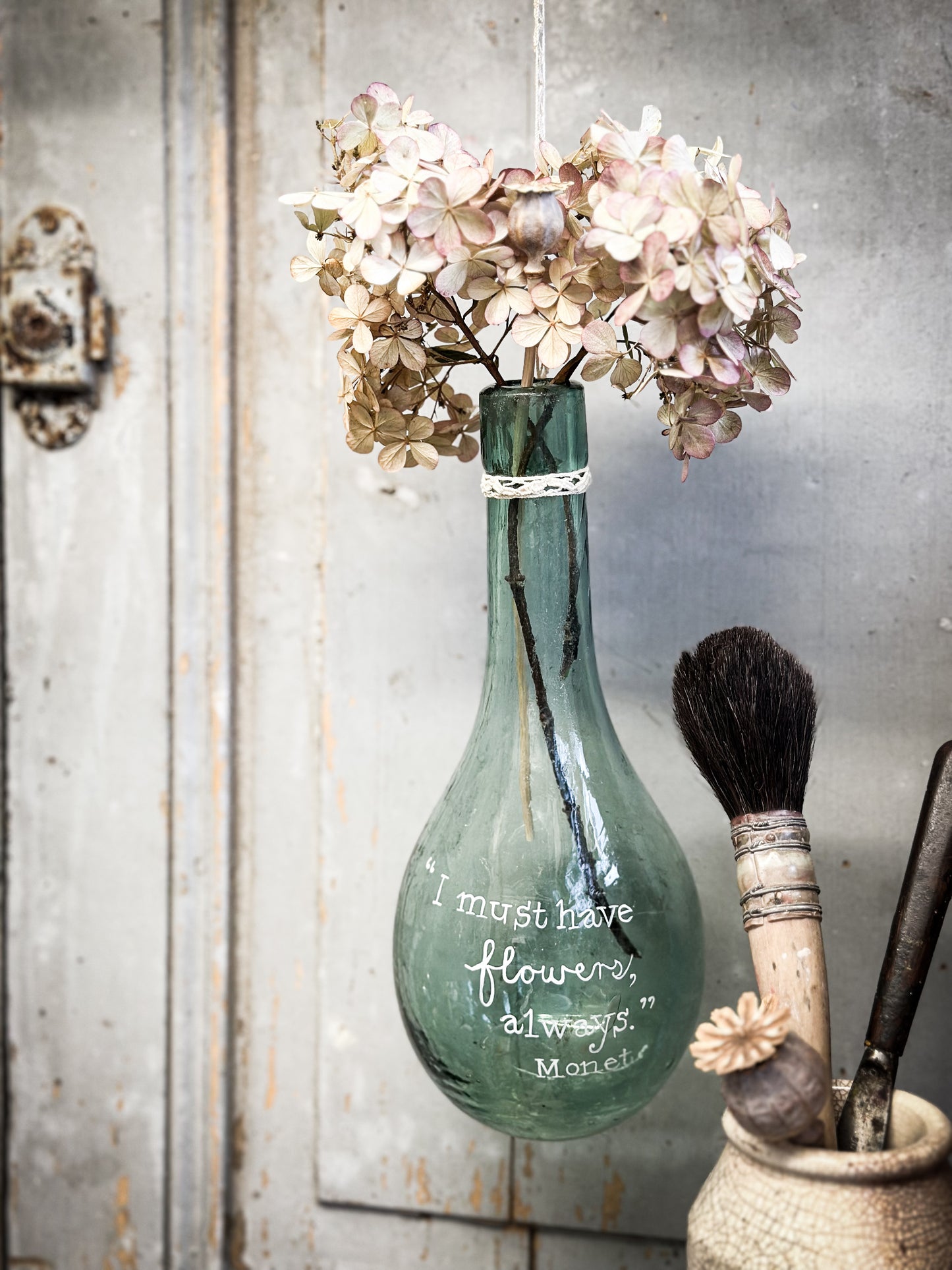 A beautiful antique hanging bulb bottle with a hand painted quote