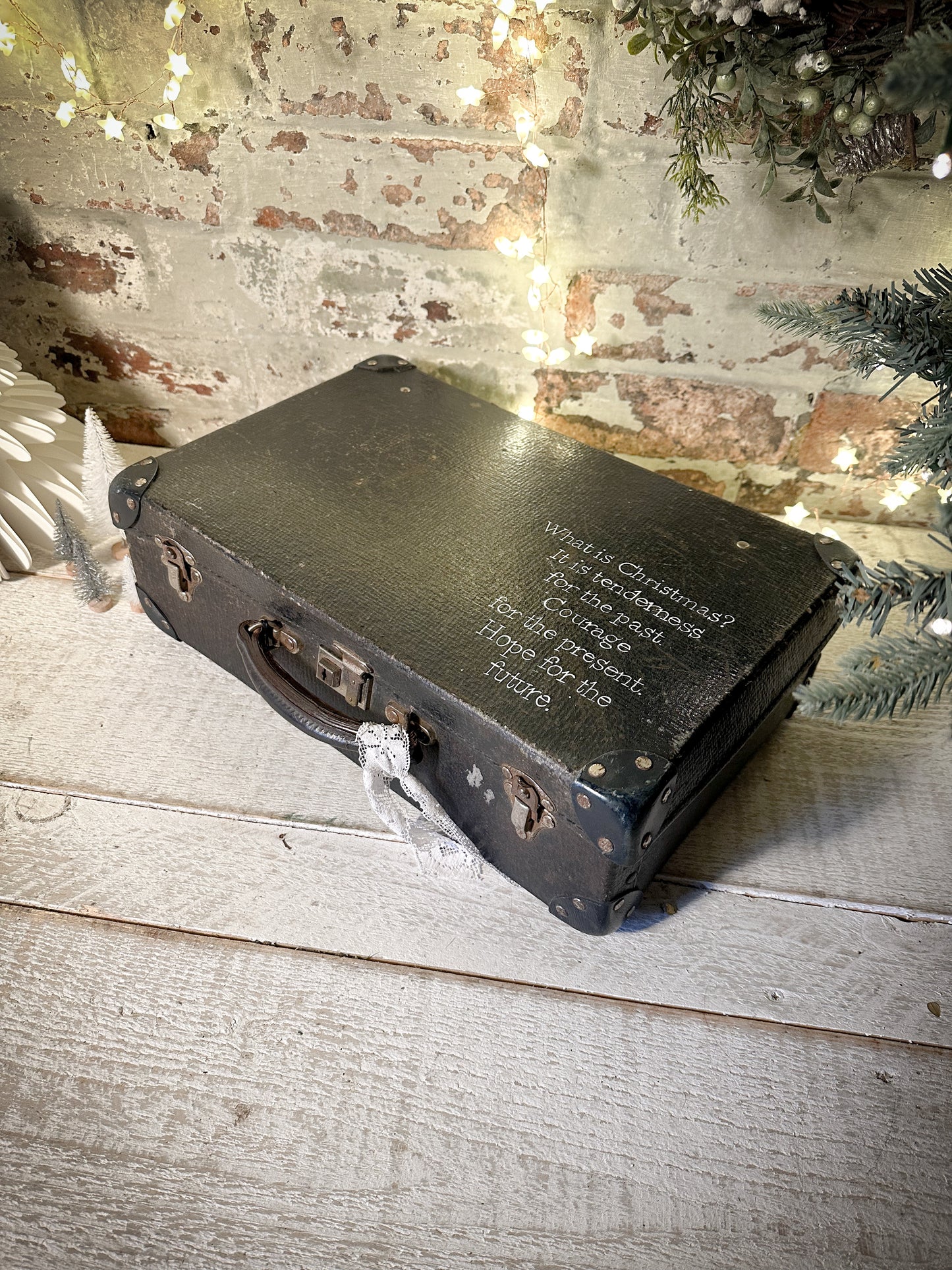 A gorgeous vintage suitcase with a hand painted quote for storing Christmas decorations