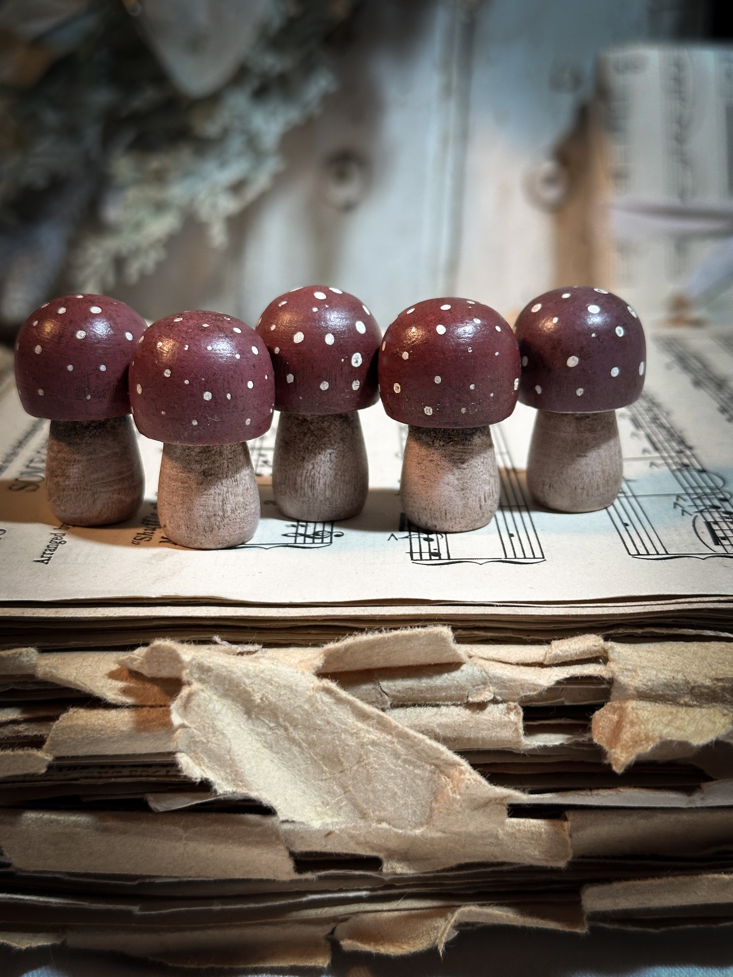 A wooden hand painted Christmas village toadstool