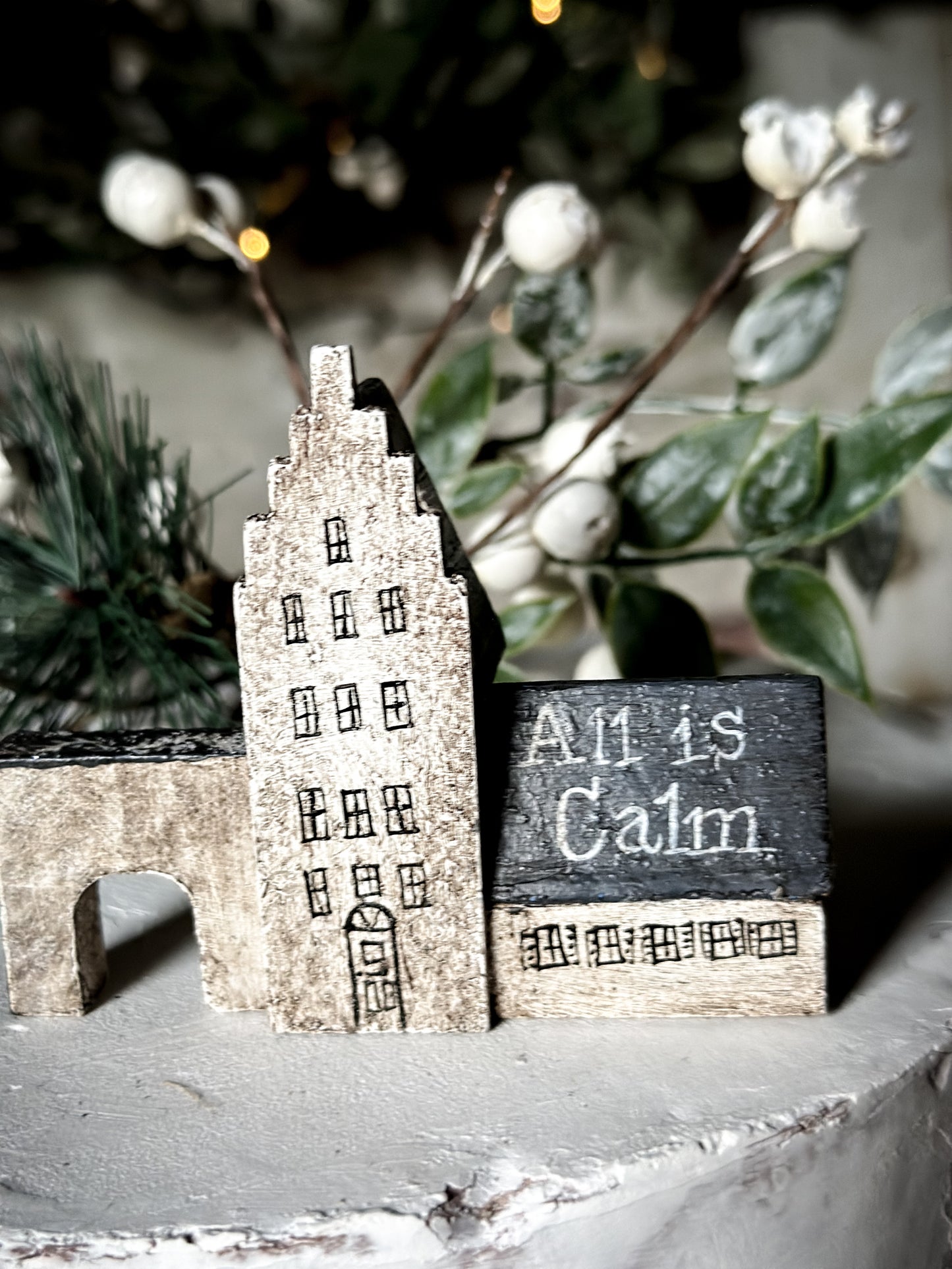 A pretty vintage German Erzgebirge Putz wooden village house painted with a Christmas quote