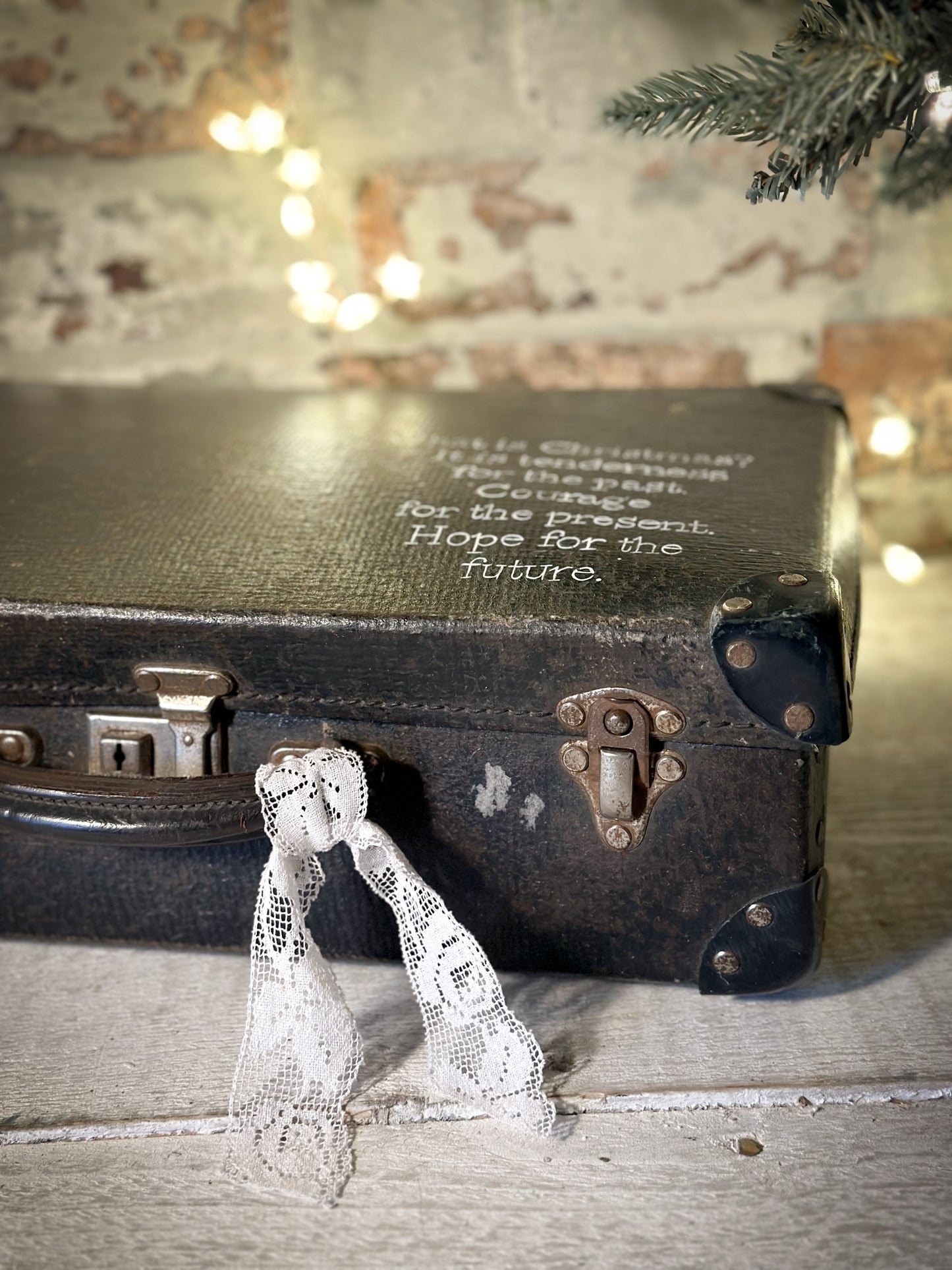 A gorgeous vintage suitcase with a hand painted quote for storing Christmas decorations