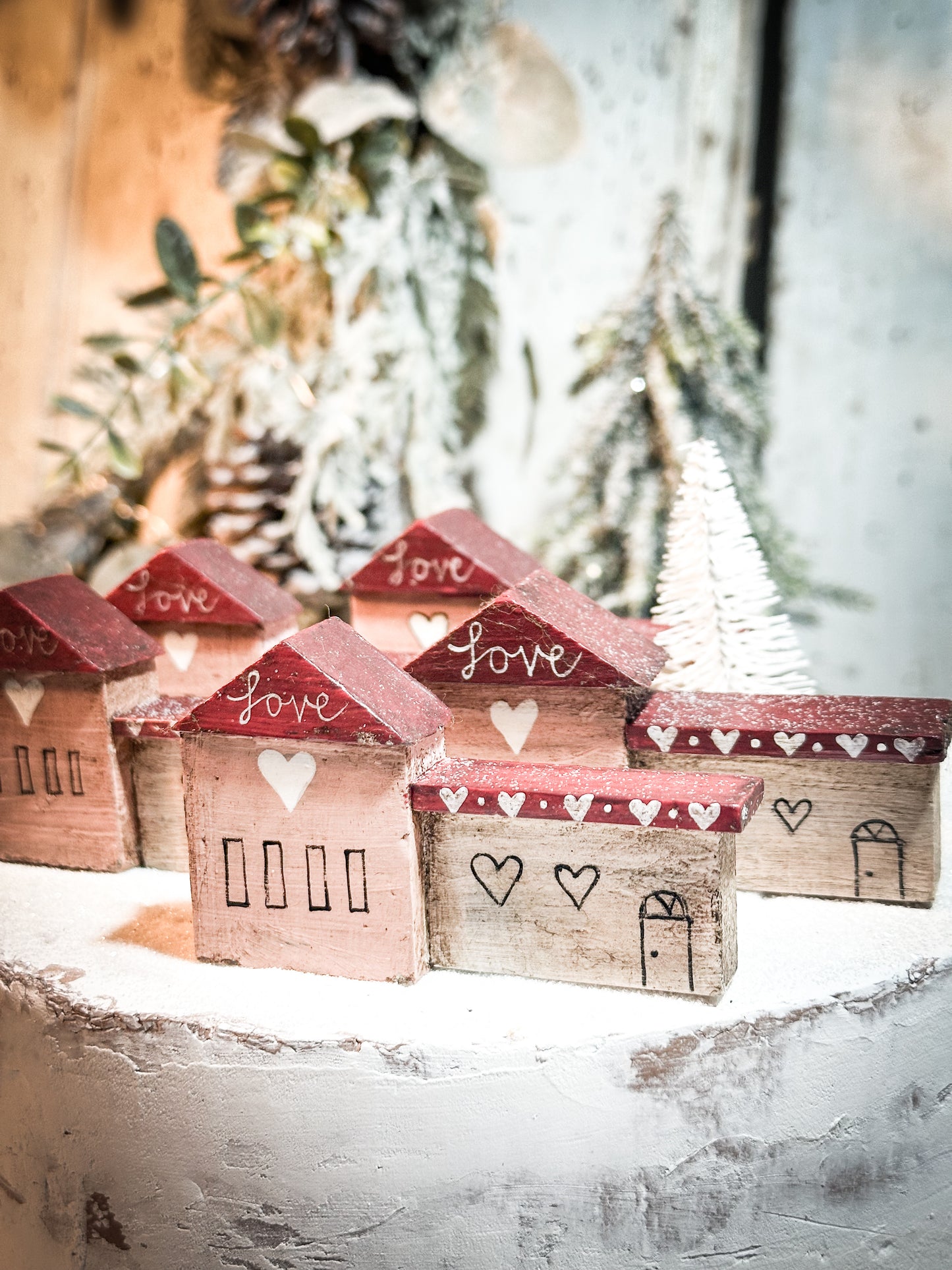 A pretty vintage German Erzgebirge Putz wooden village house painted with a Christmas quote