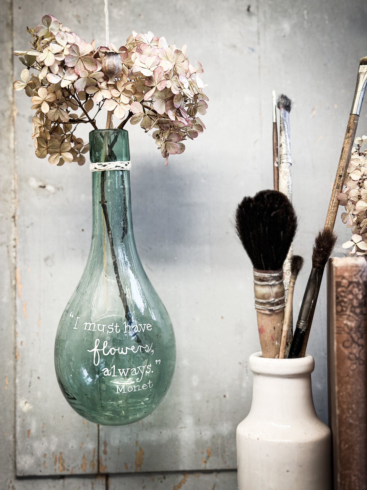 A beautiful antique hanging bulb bottle with a hand painted quote