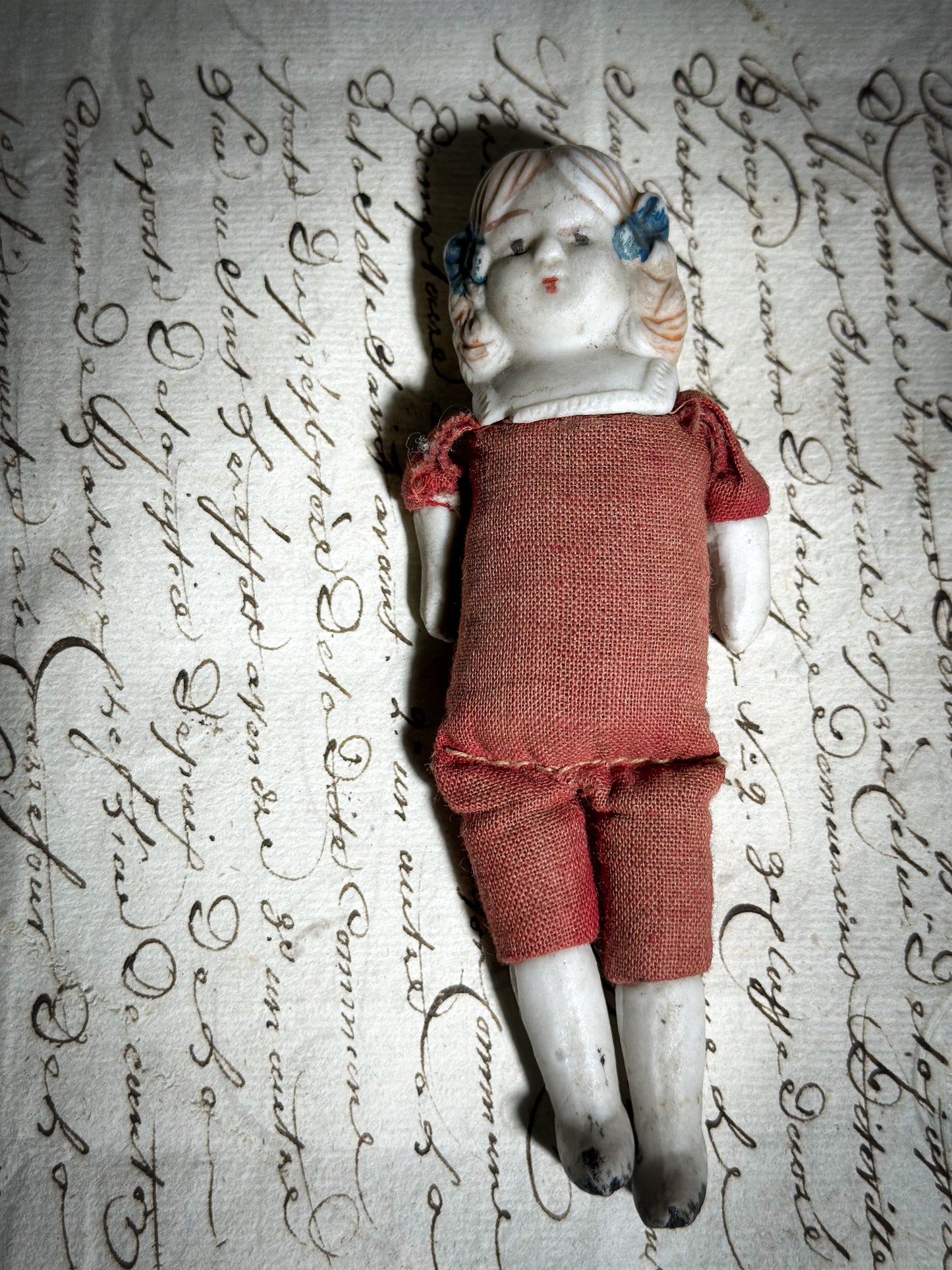 A vintage bisque head and shoulder doll