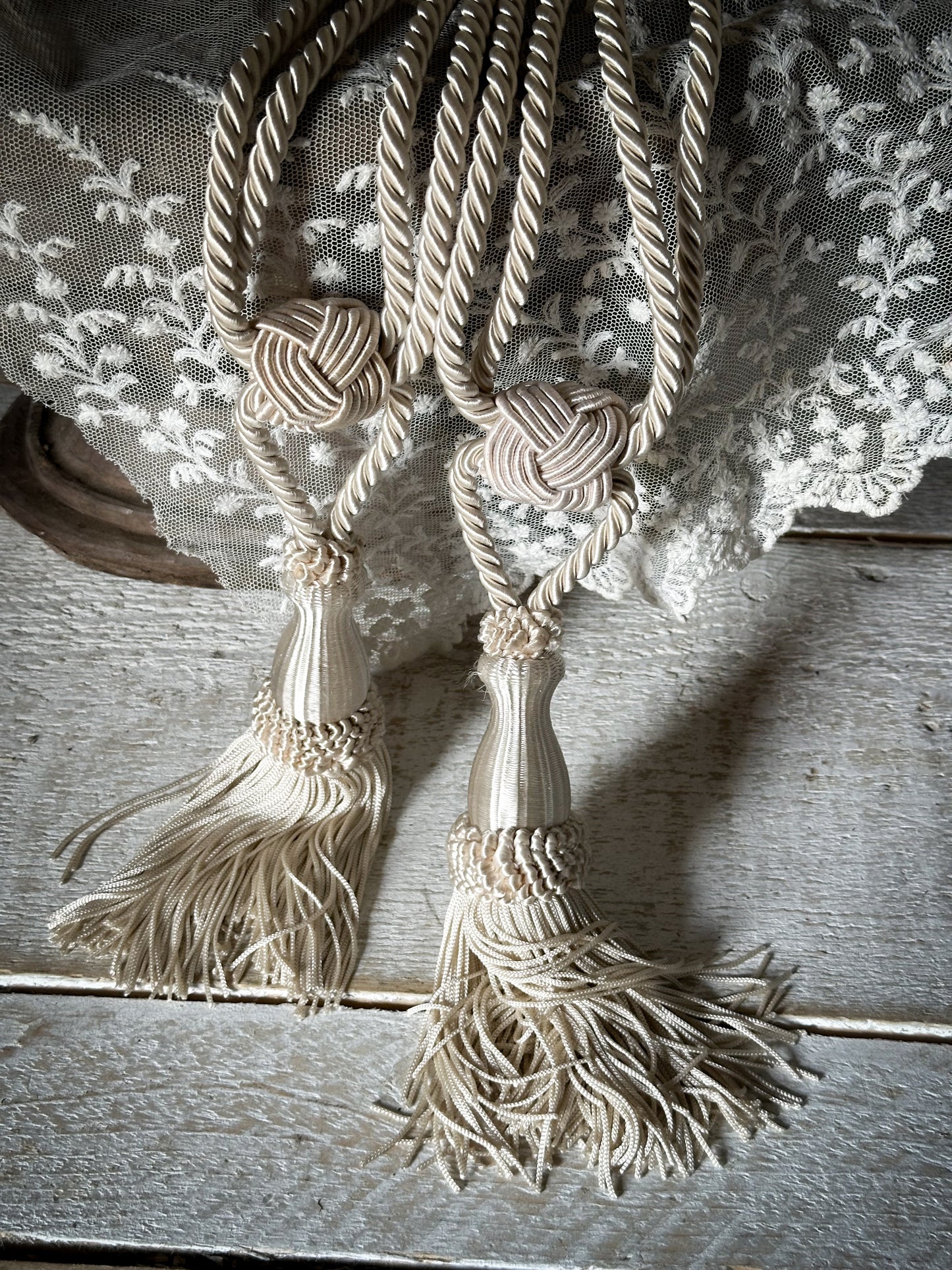 A pair of pretty vintage ivory curtain tie backs