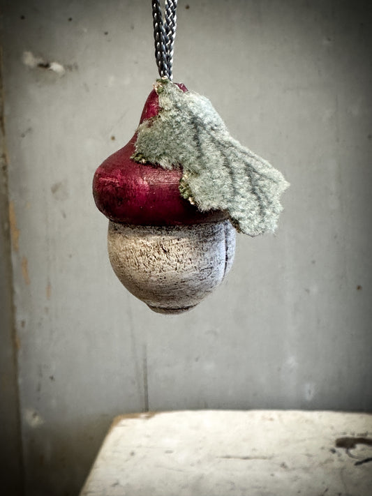A wooden hand painted and trimmed Plum Acorn Decoration