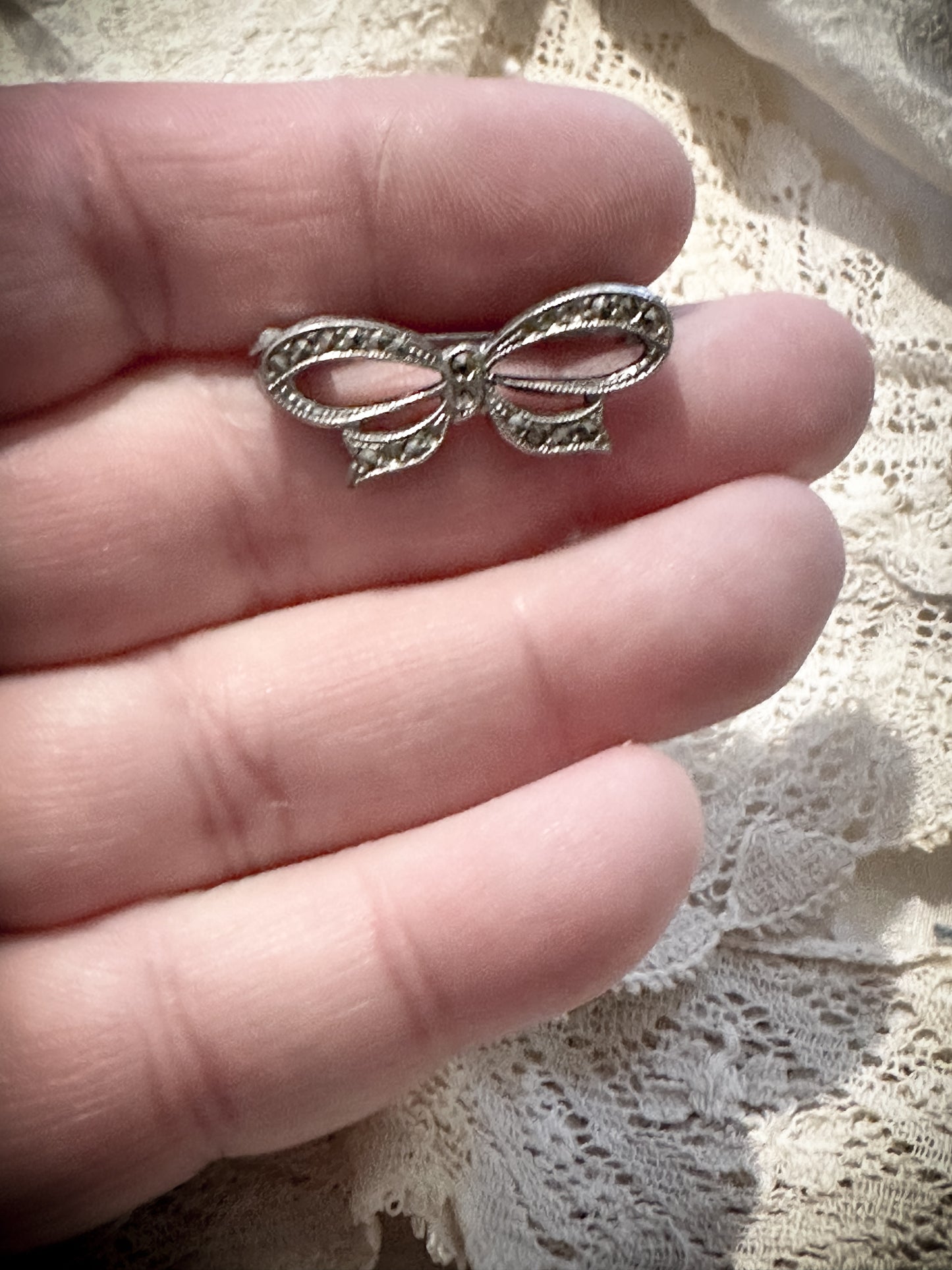 A miniature marcasite bow brooch