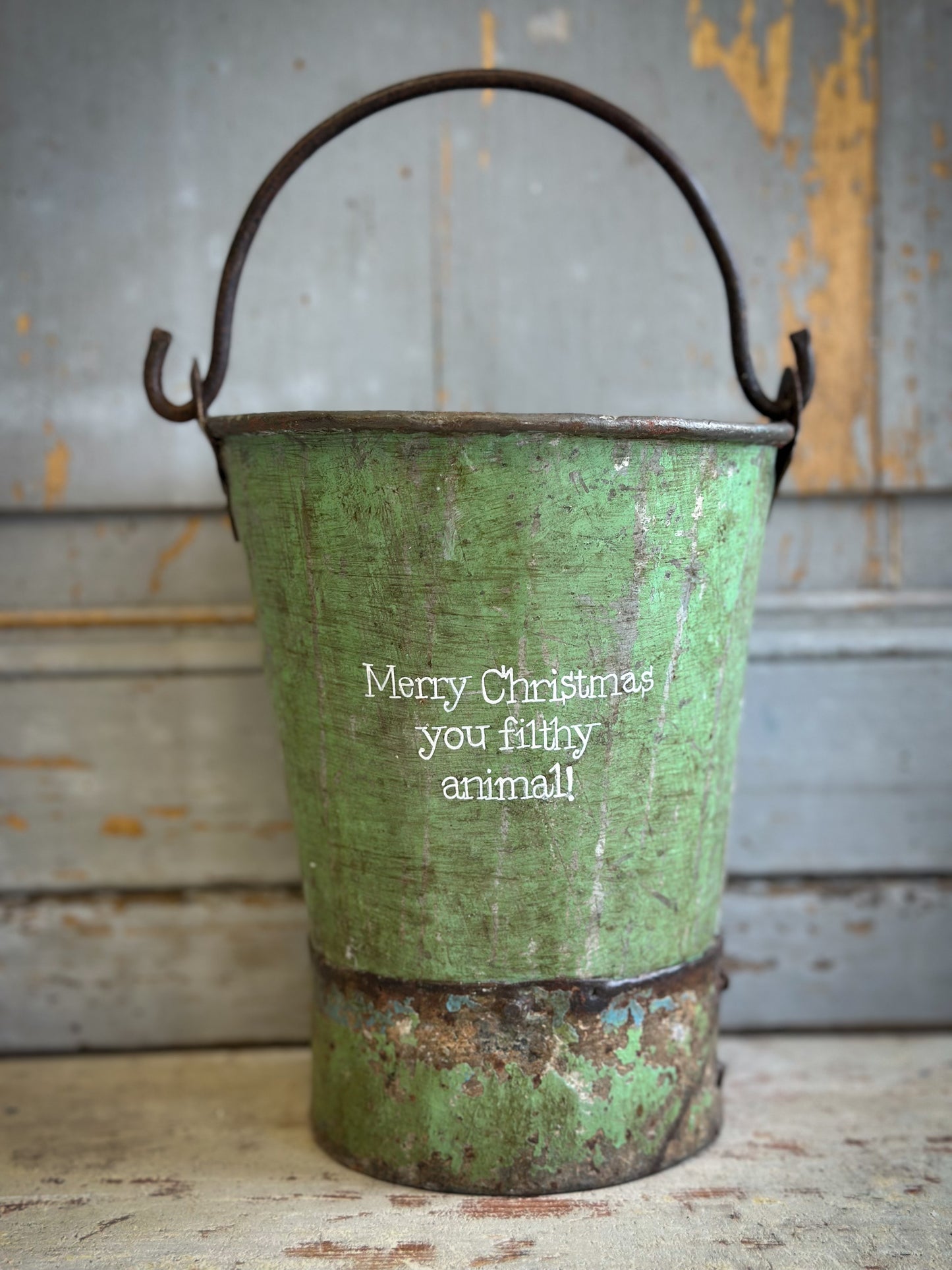 A Recycled Metal Mini Christmas Tree Bucket With A Hand Painted Quote