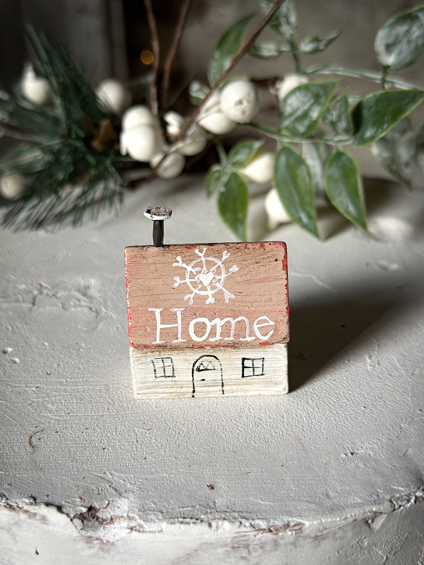 A pretty vintage German Erzgebirge Putz wooden village house painted with a Christmas quote