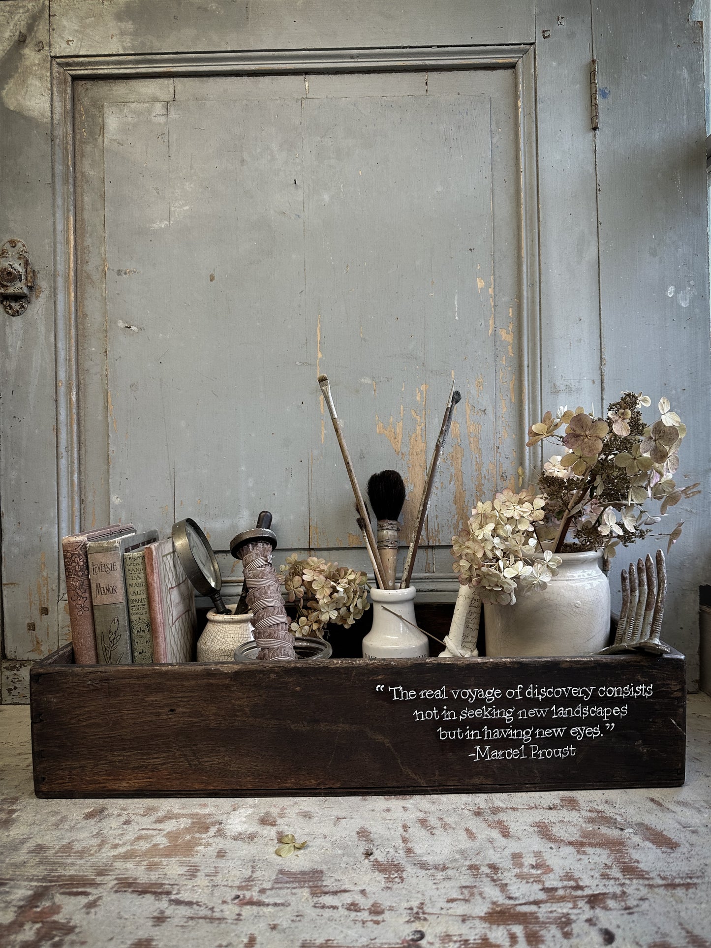 A Vintage Wooden Crate With Hand Painted Quote