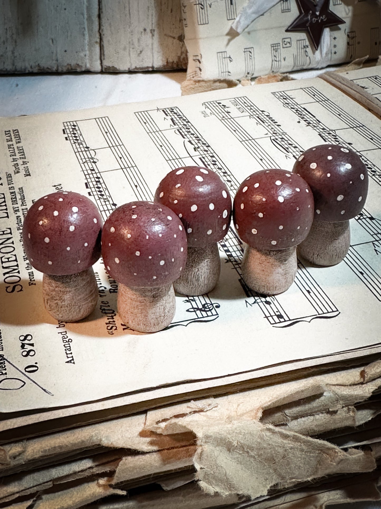 A wooden hand painted Christmas village toadstool