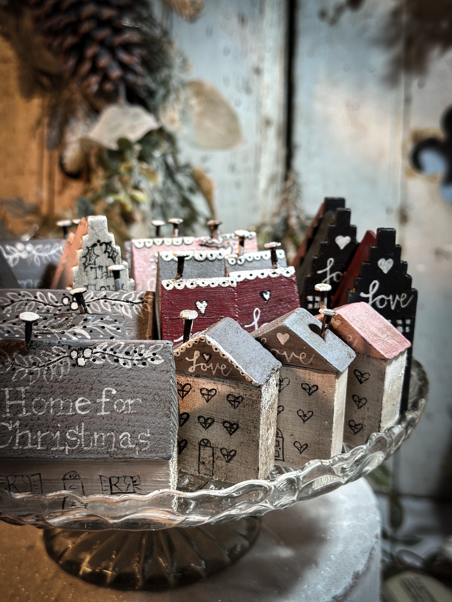 A pretty vintage German Erzgebirge Putz wooden village house painted with a Christmas quote