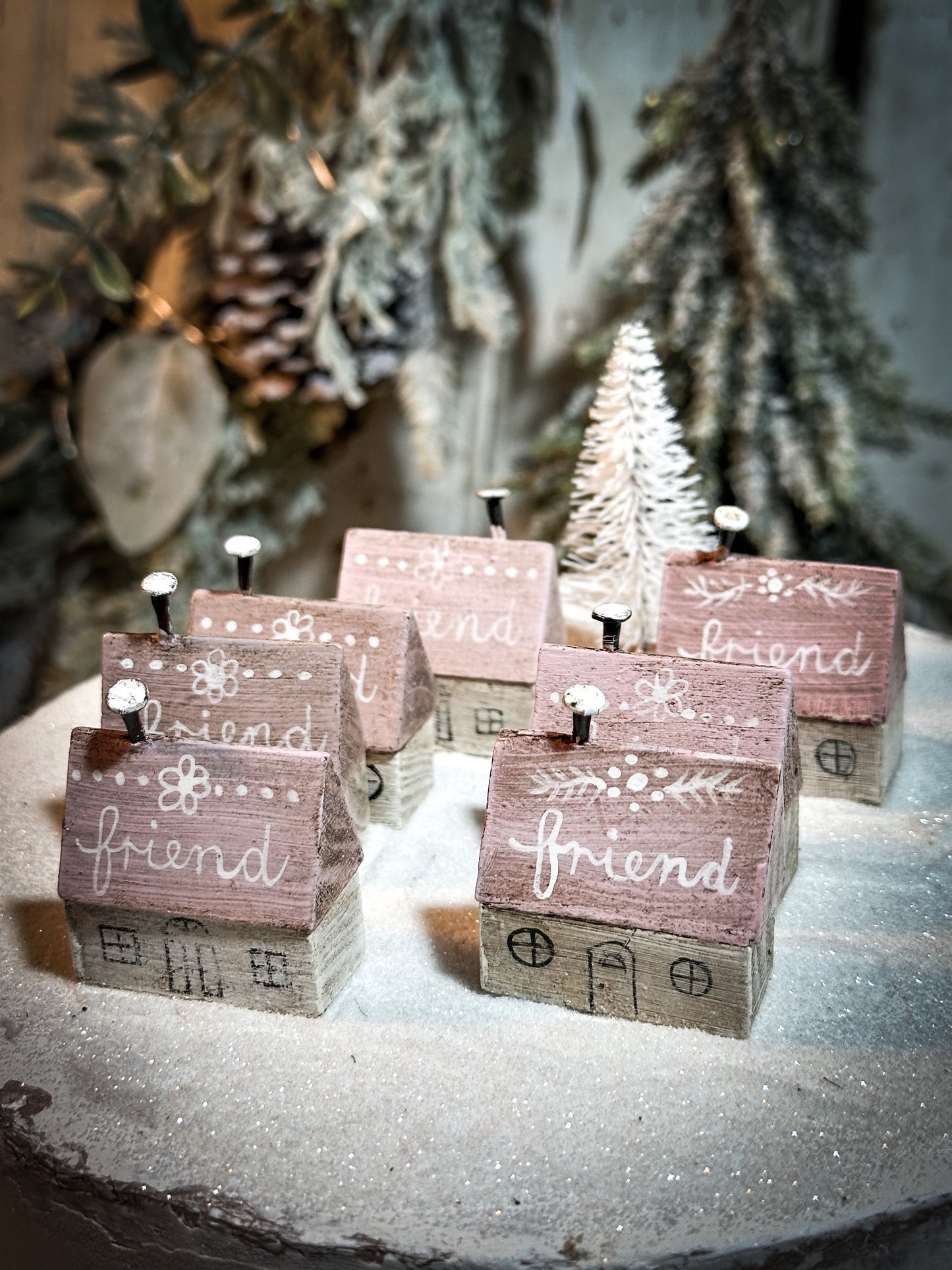 A pretty vintage German Erzgebirge Putz wooden village house painted with a Christmas quote