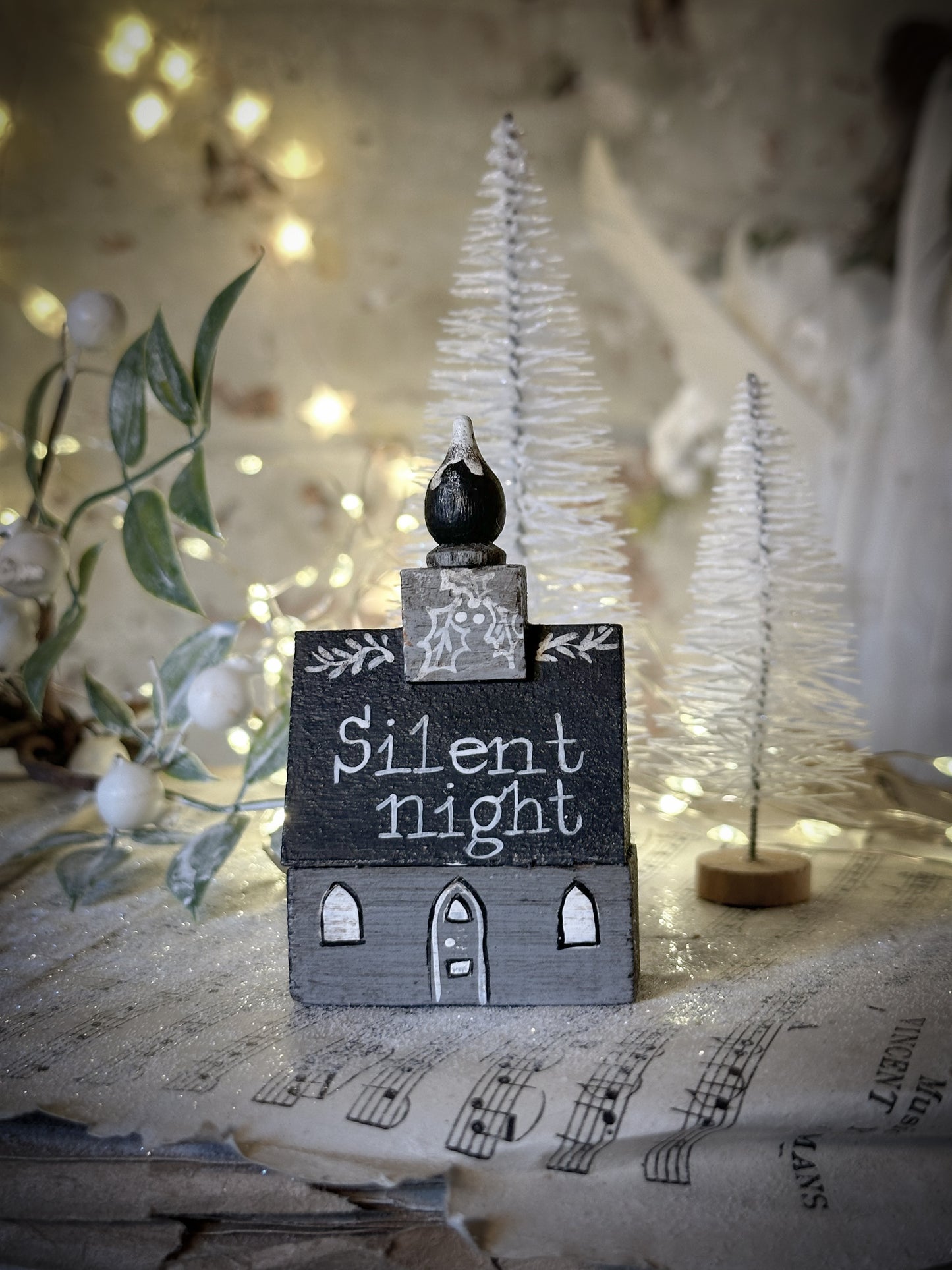 A pretty vintage German Erzgebirge Putz wooden village house painted with a Christmas quote