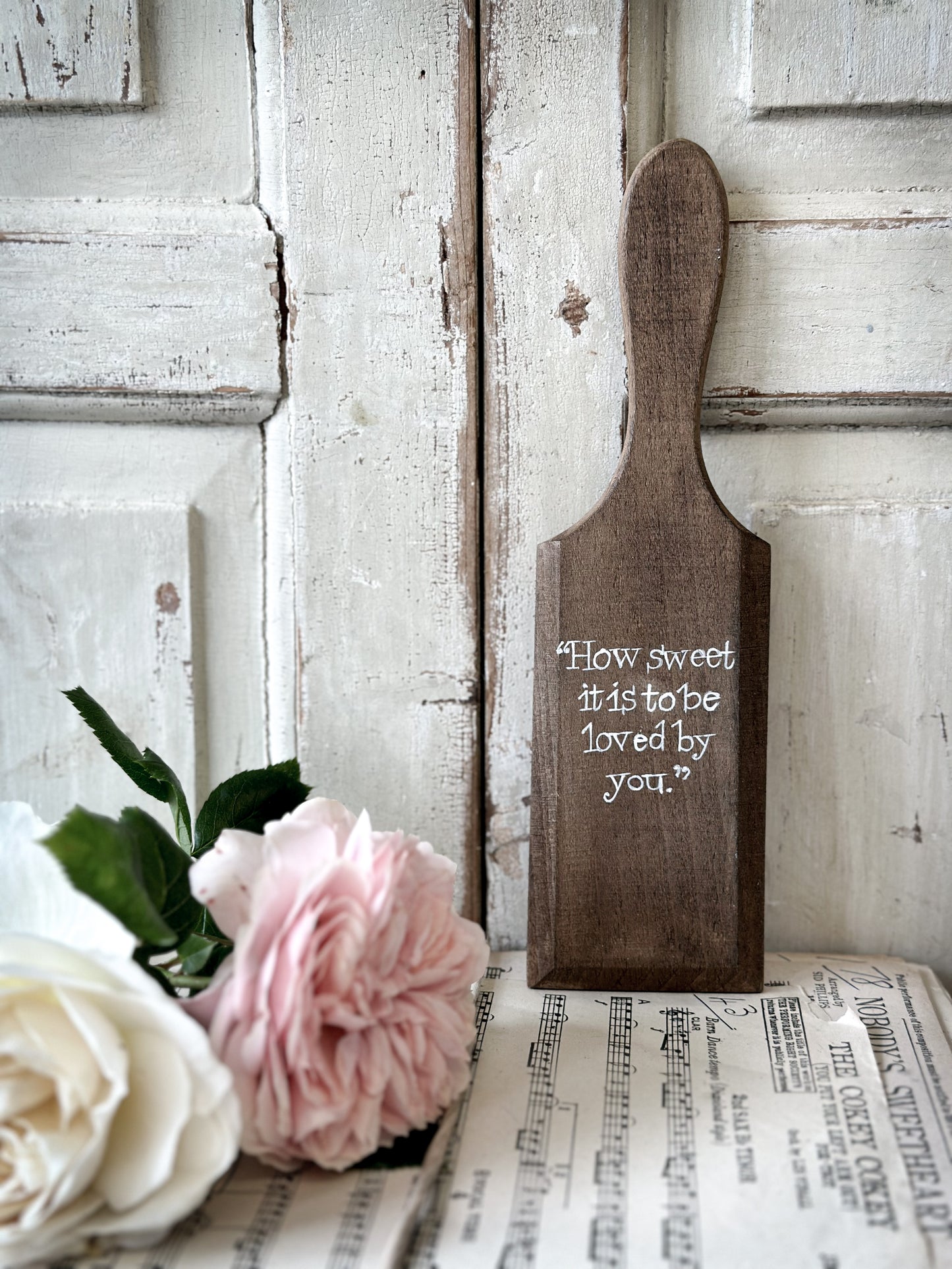 A hand painted vintage wooden butter pat “How sweet it is”