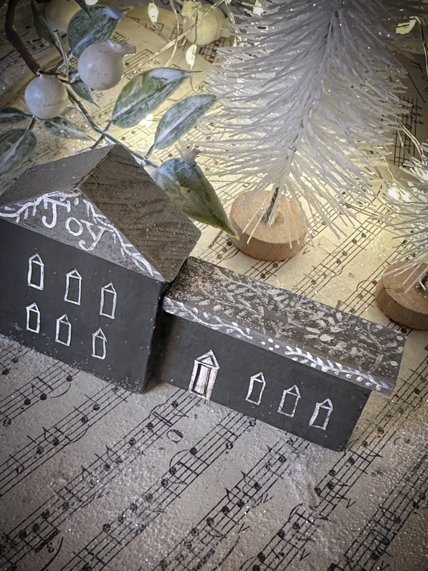 A pretty vintage German Erzgebirge Putz wooden village house painted with a Christmas quote