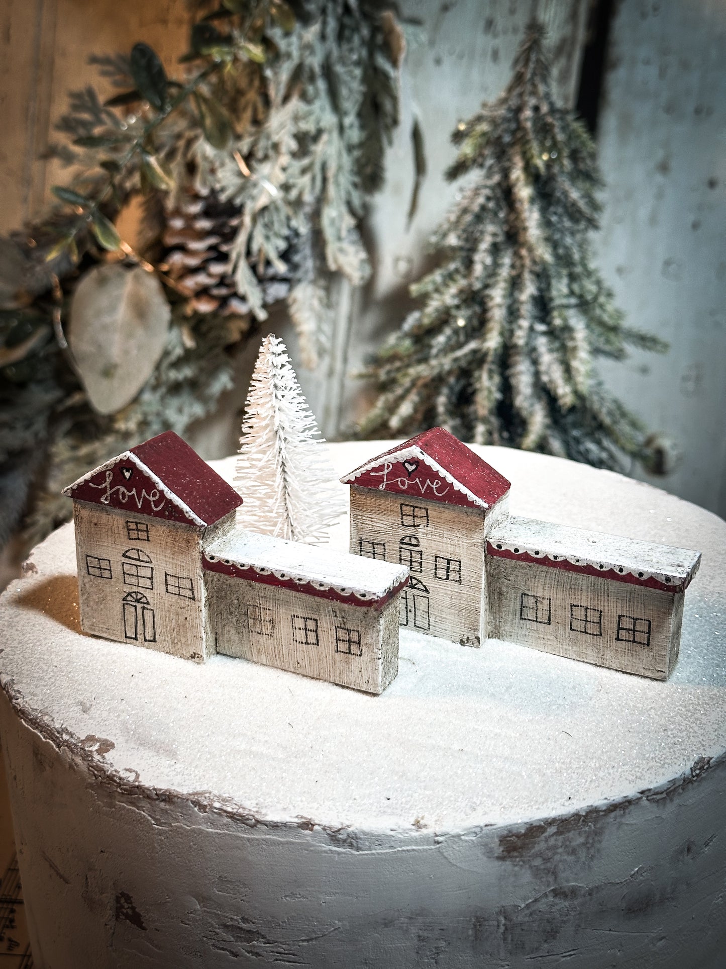 A pretty vintage German Erzgebirge Putz wooden village house painted with a Christmas quote