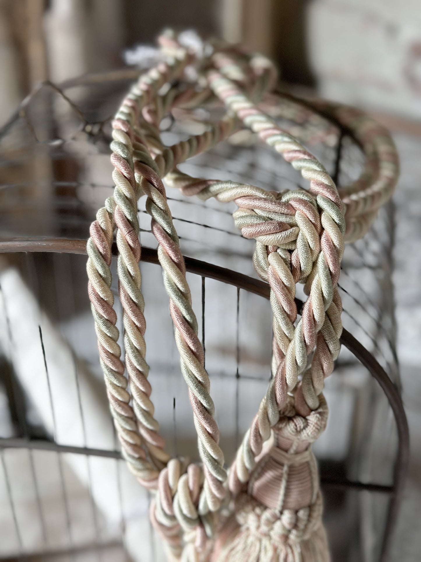 A pair of pretty vintage pastel pink, sage green and ivory curtain tie backs