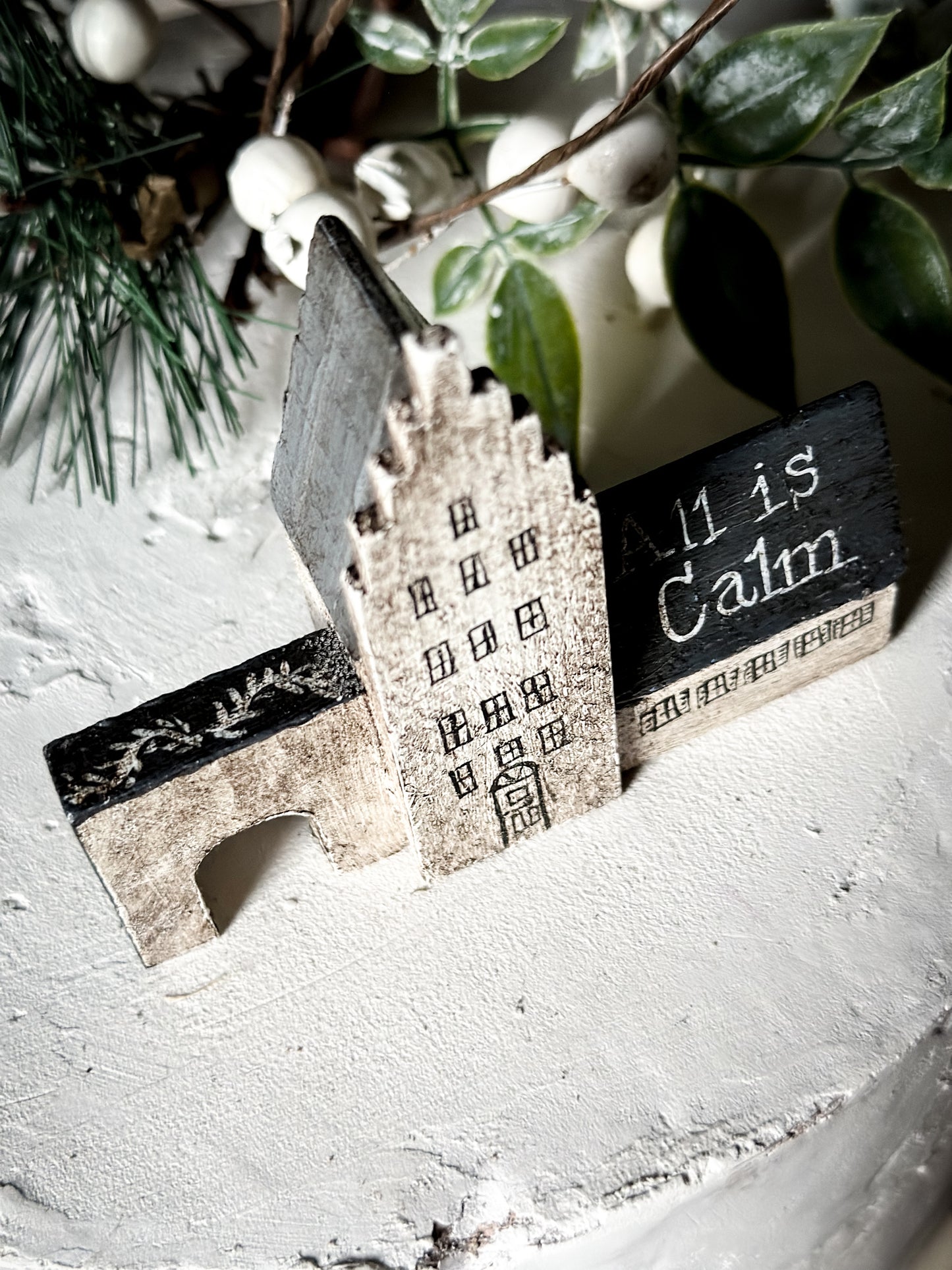 A pretty vintage German Erzgebirge Putz wooden village house painted with a Christmas quote