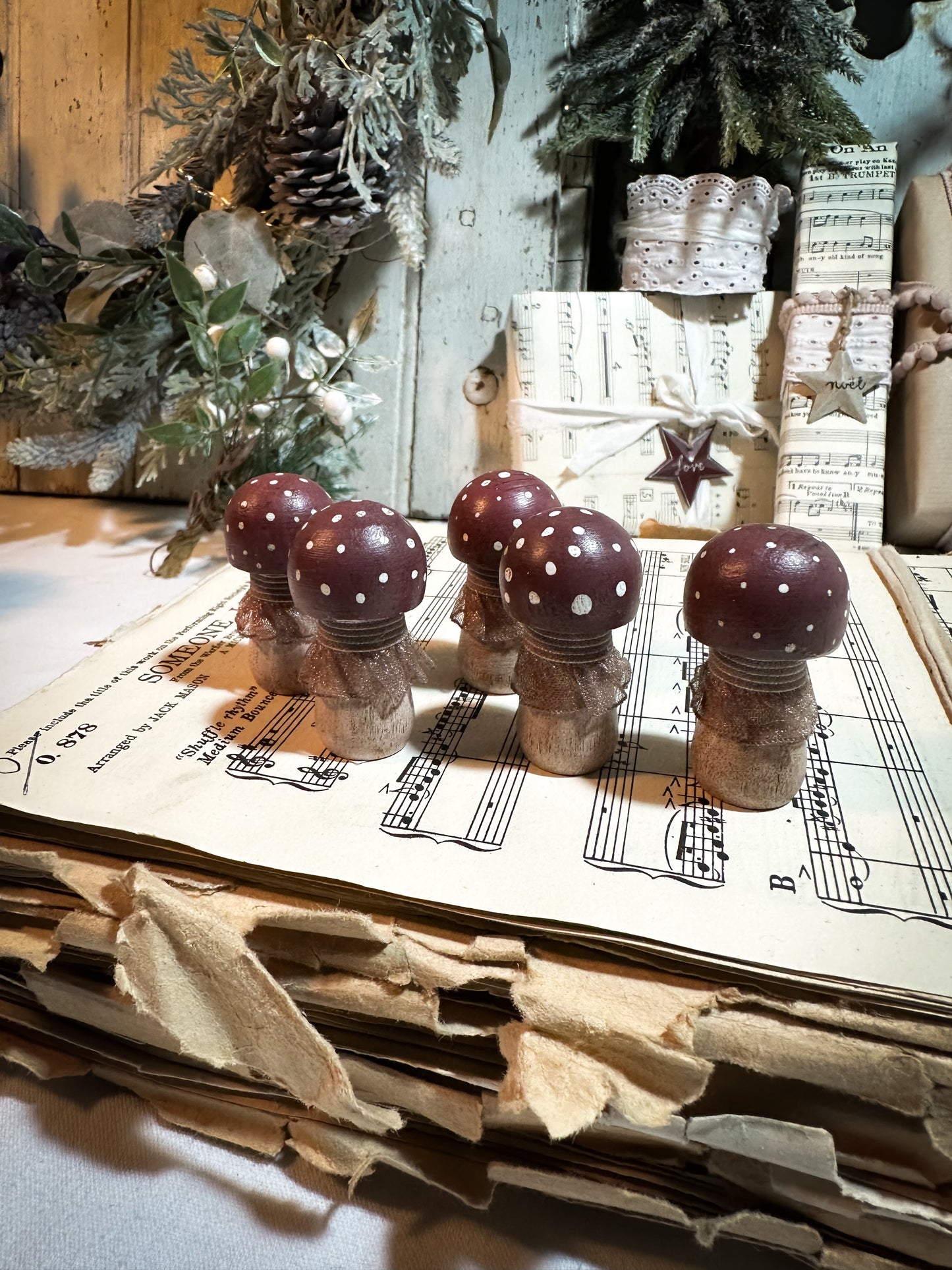 A wooden hand painted and trimmed Christmas village toadstool