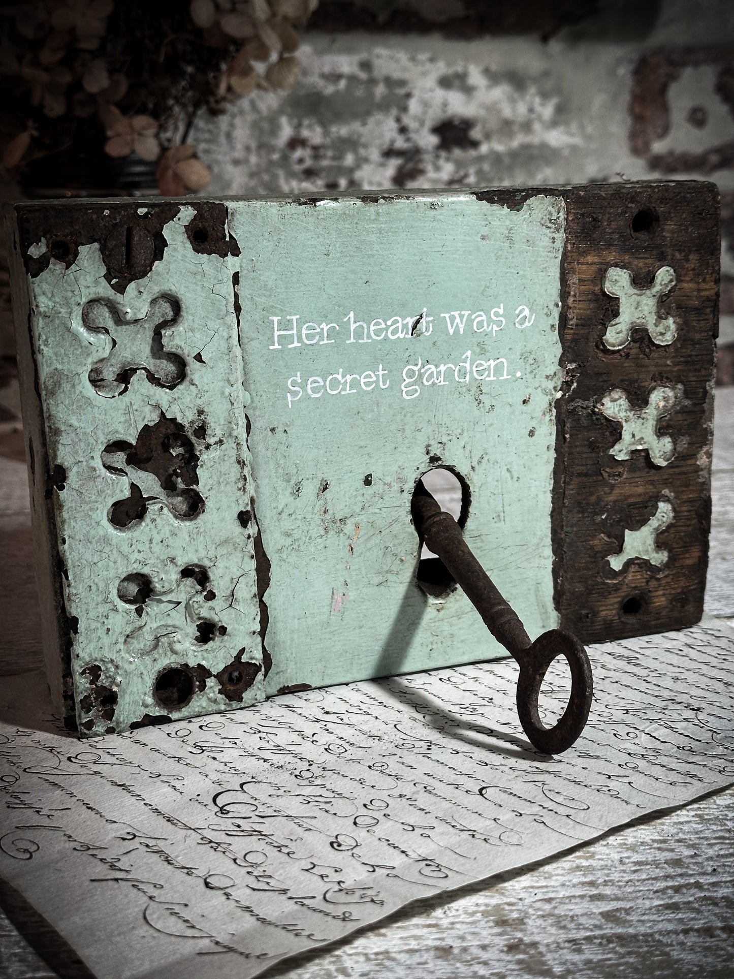 A salvaged original door lock with a painted quote