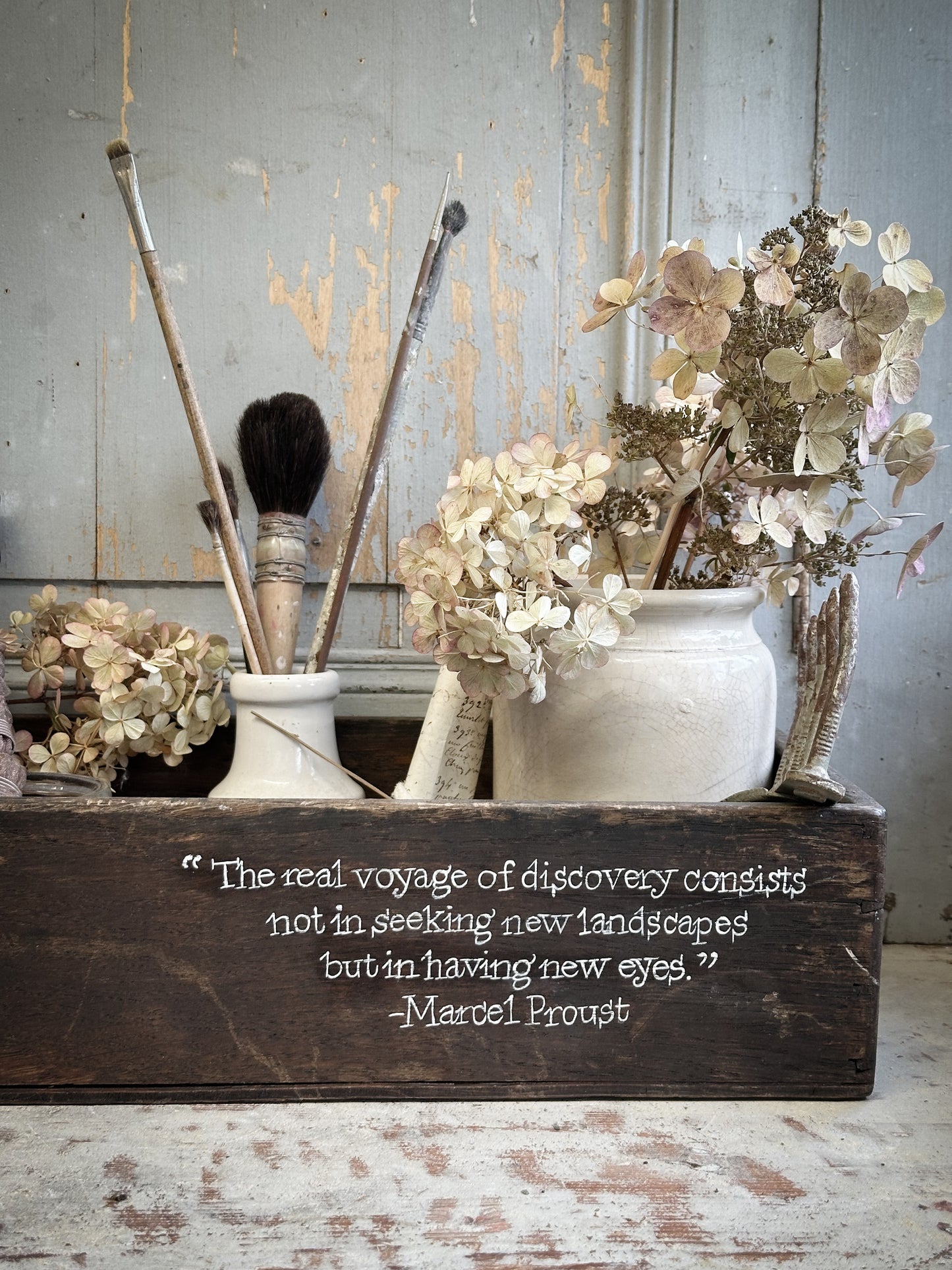 A Vintage Wooden Crate With Hand Painted Quote